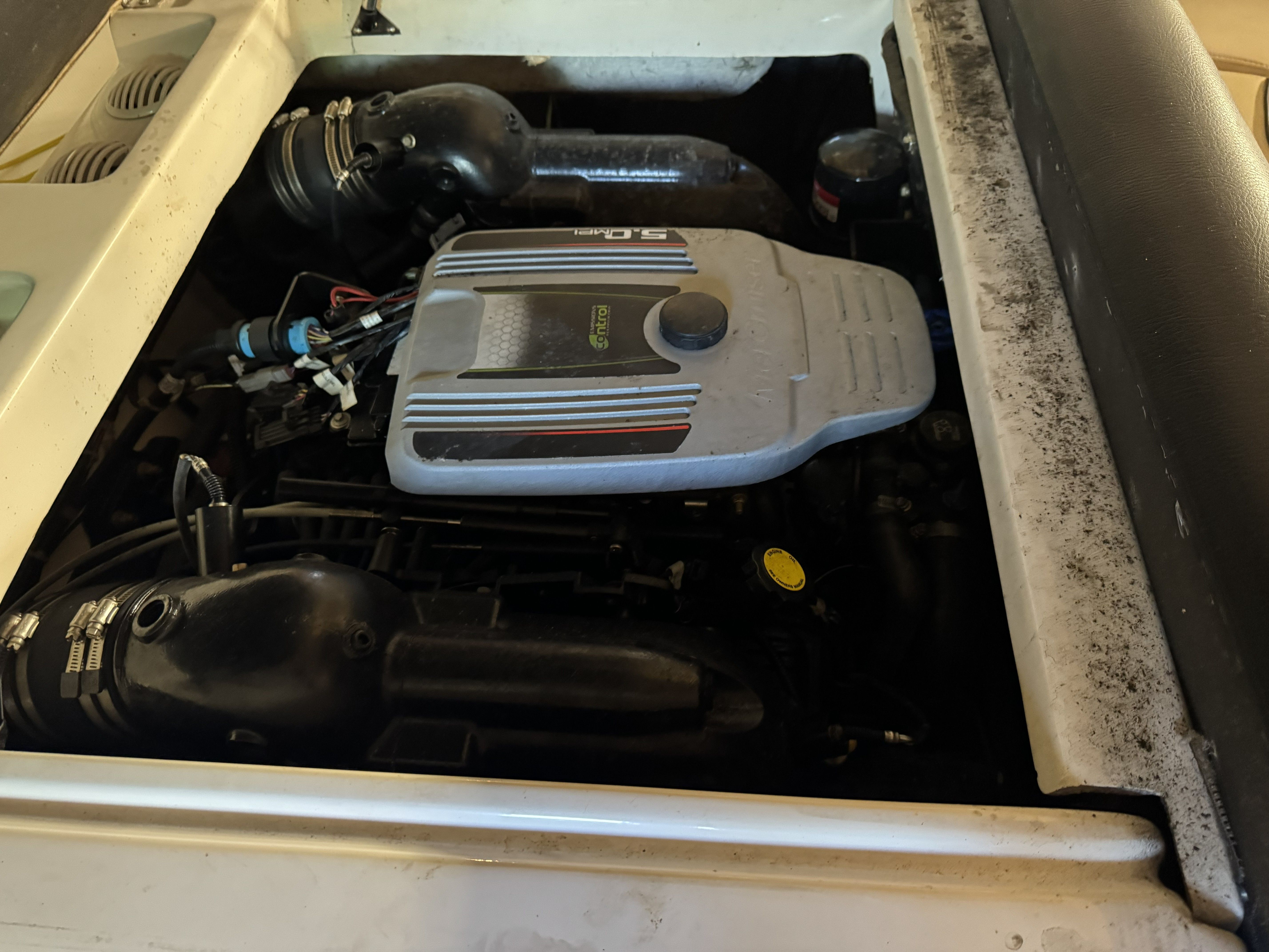The engine compartment of a 2014 Hurricane SS201 I/O boat with visible engine and components.