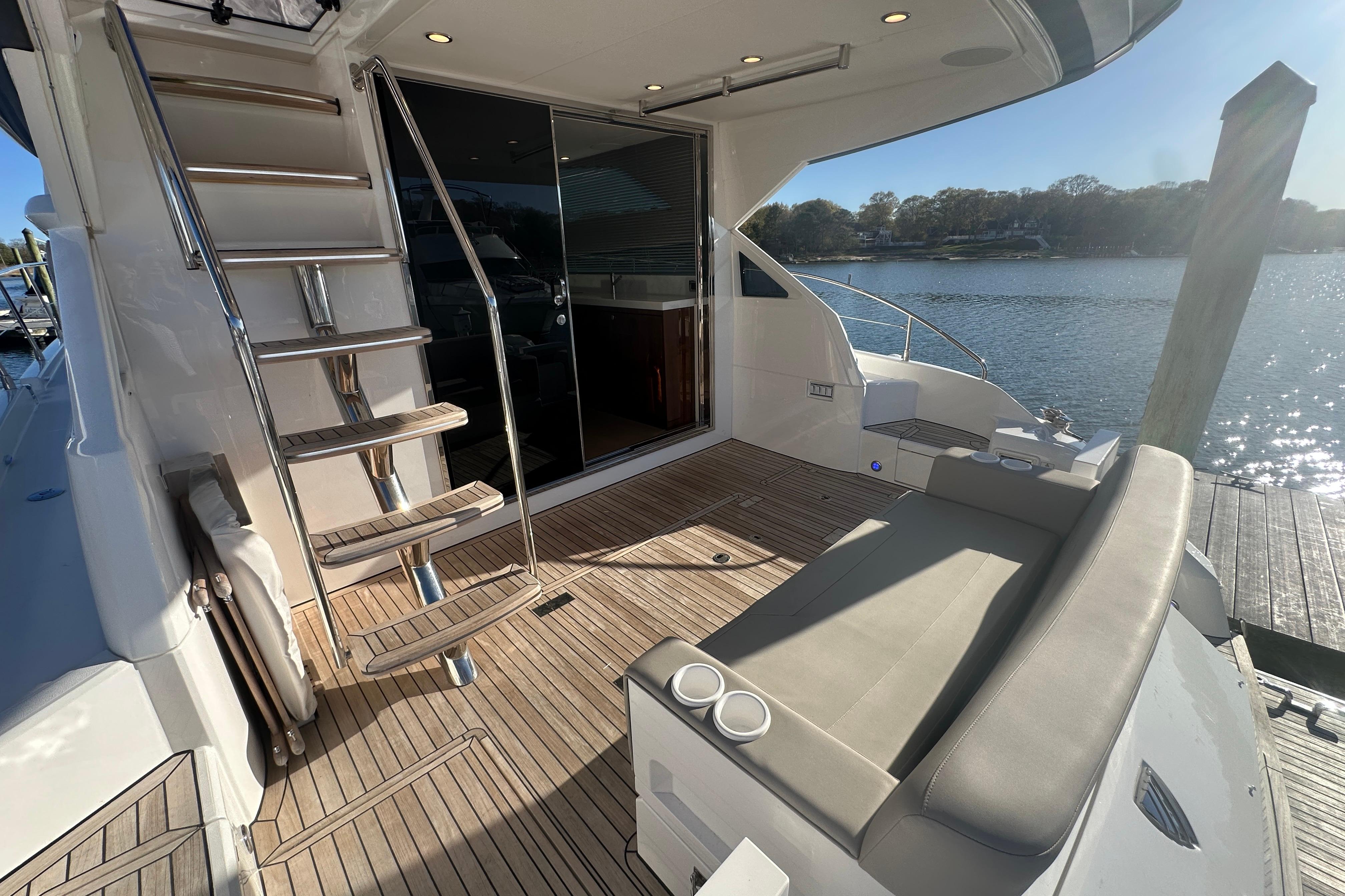 Luxury 2024 Fairline Squadron 50 yacht deck with seating and water view.