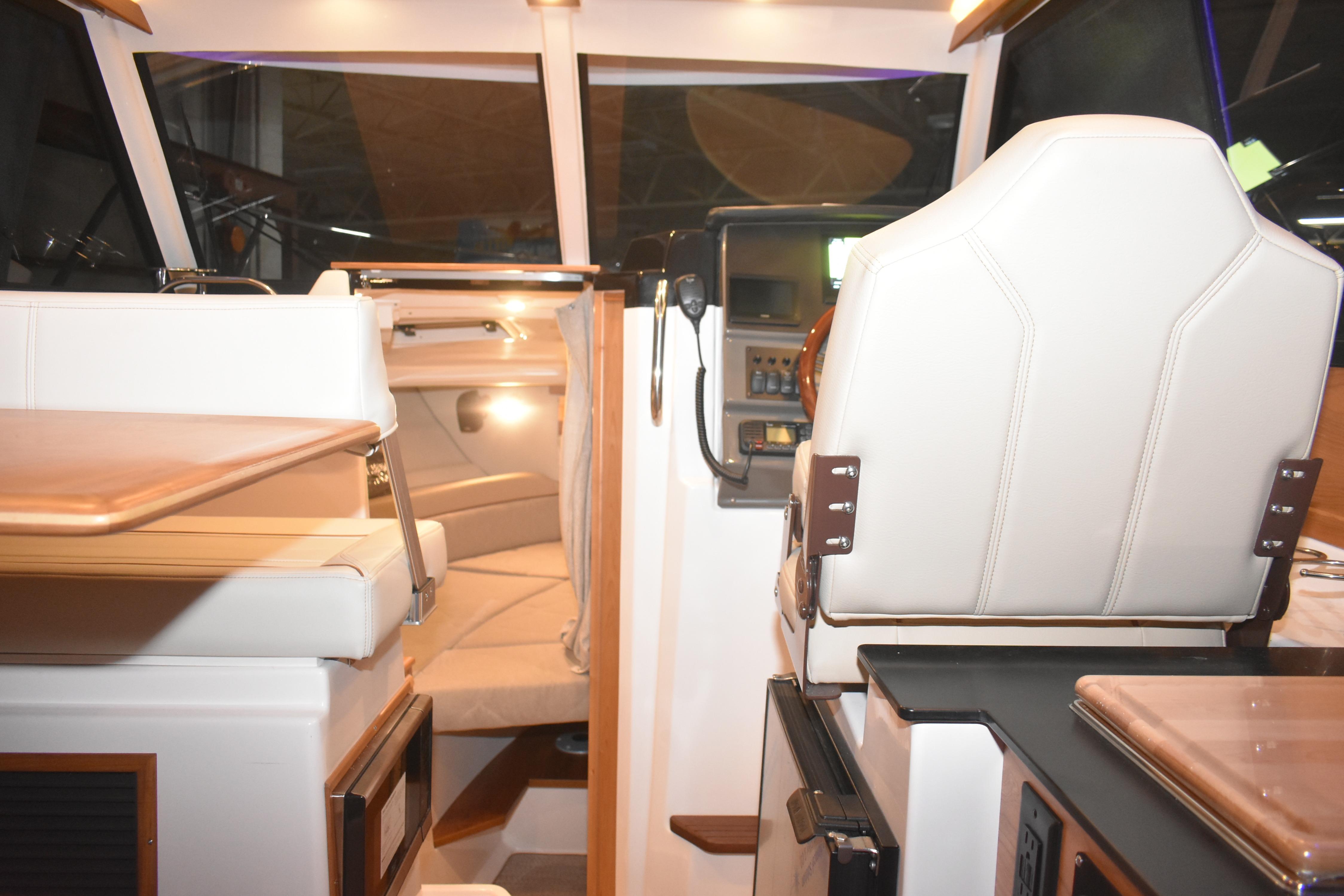 Interior of 2026 Cutwater C-248 Coupe, featuring helm and seating area.
