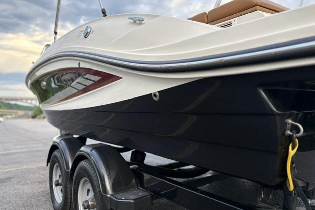 2017 Searay SPX210 boat on trailer, side view with sleek design.