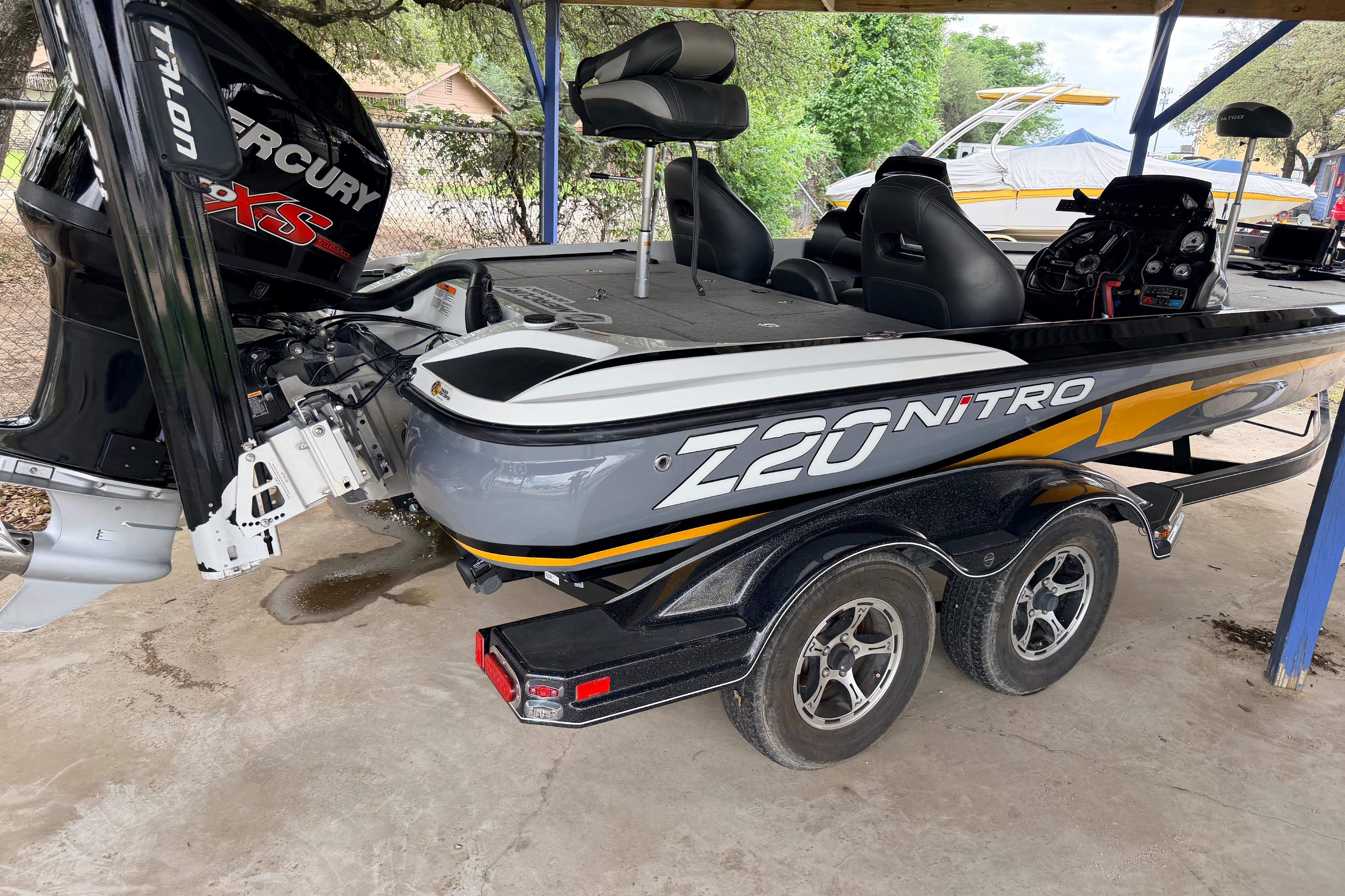 2016 Nitro Z20 boat with Mercury engine, parked on a trailer under a shelter.