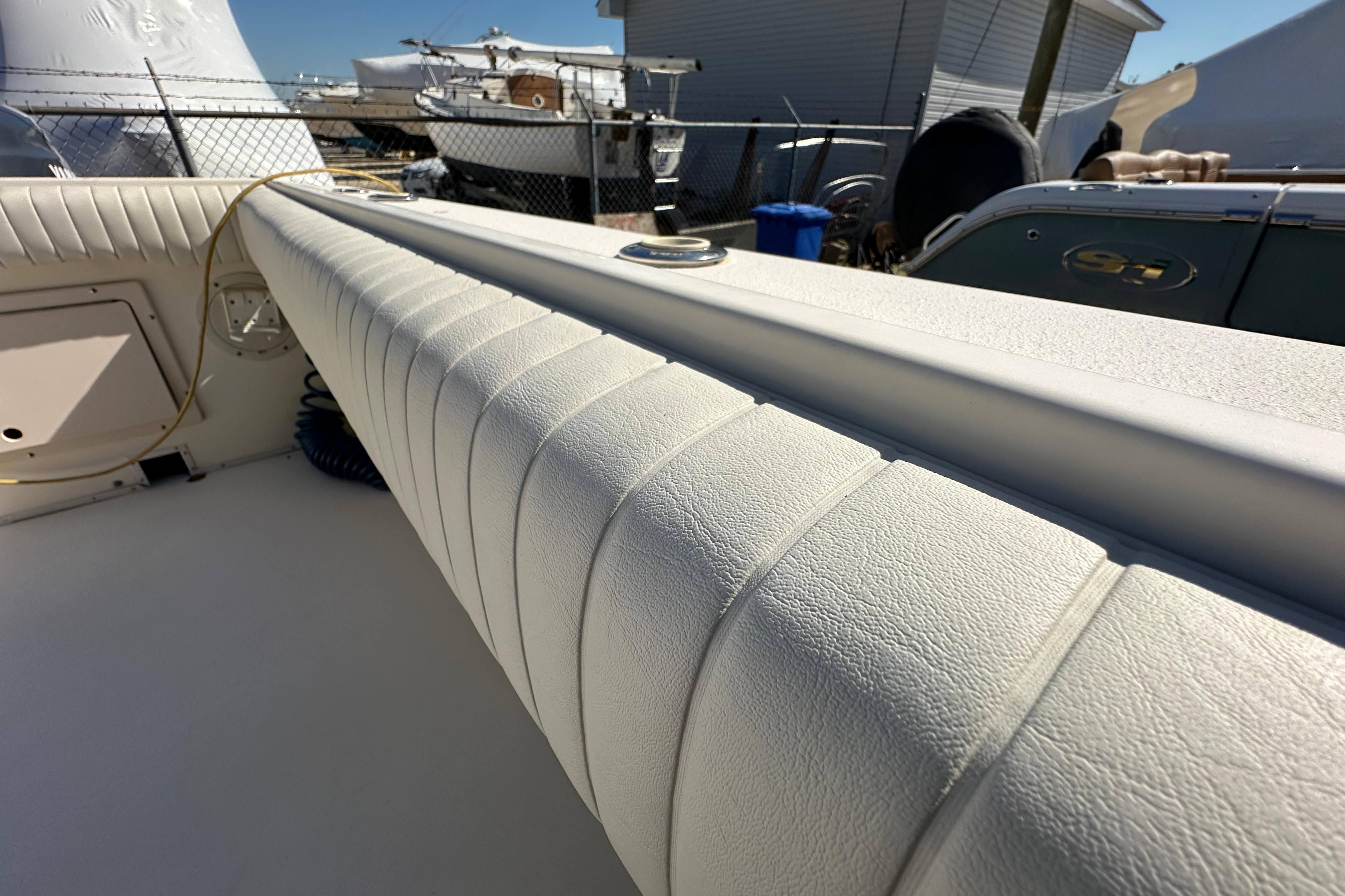 2001 Parker 2510 Deep Vee Walkaround boat interior with cushioned seating and deck details.