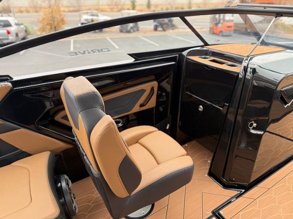 Interior of 2025 Yamaha Boats 255XD, featuring sleek black and tan seating and modern design.