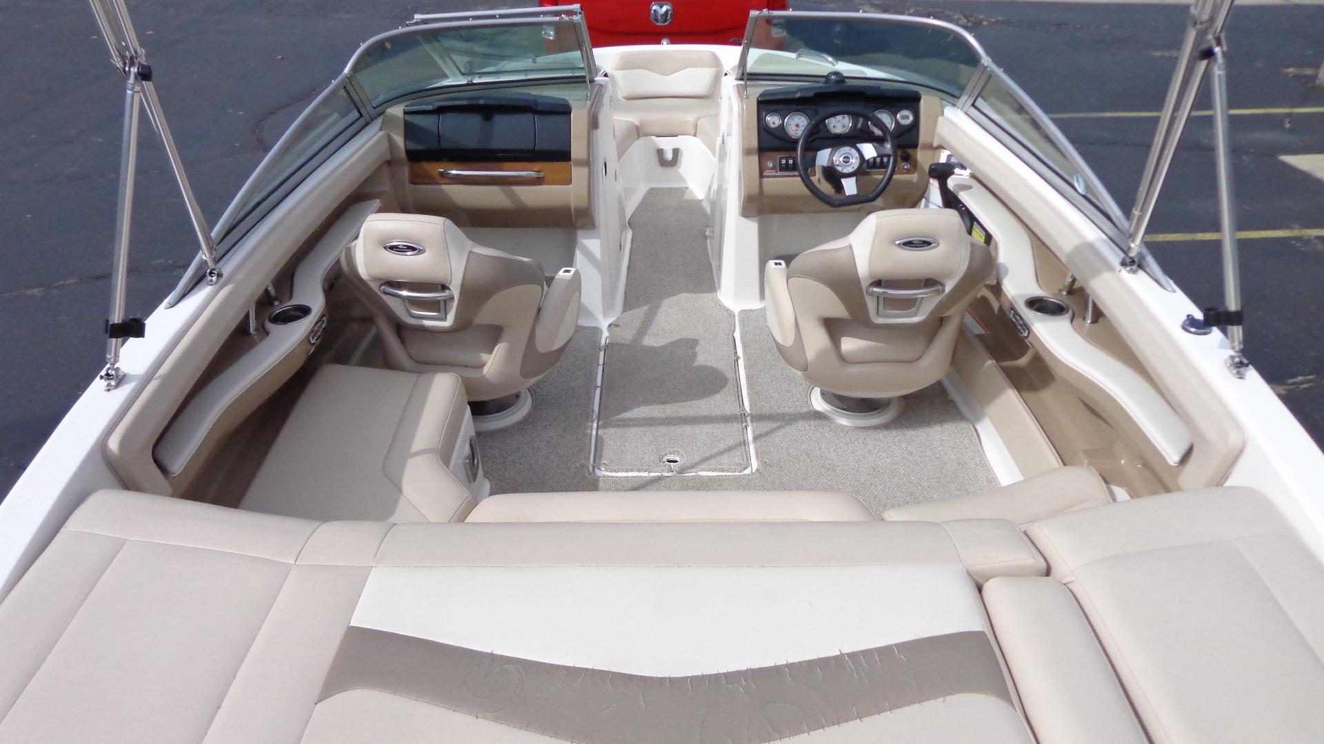 2011 Chaparral 206 SSi boat interior with beige seating and steering console.