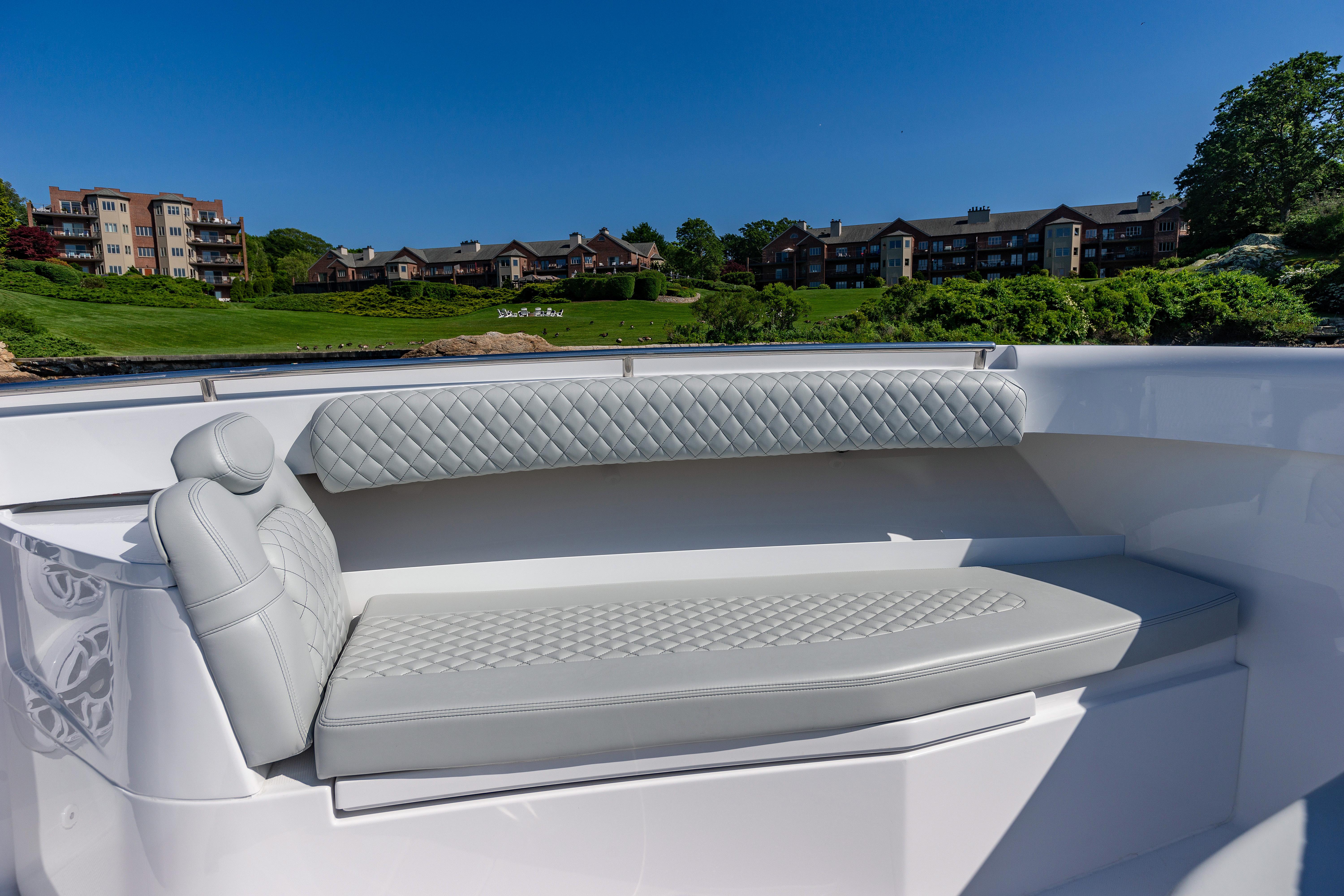 2024 HCB 39 Speciale boat with luxurious seating and scenic background.