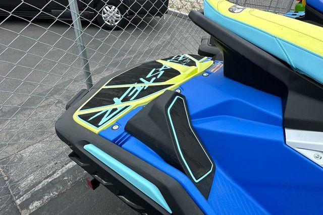 Close-up of a blue and yellow Yamaha WaveRunner jet ski parked on a lot.