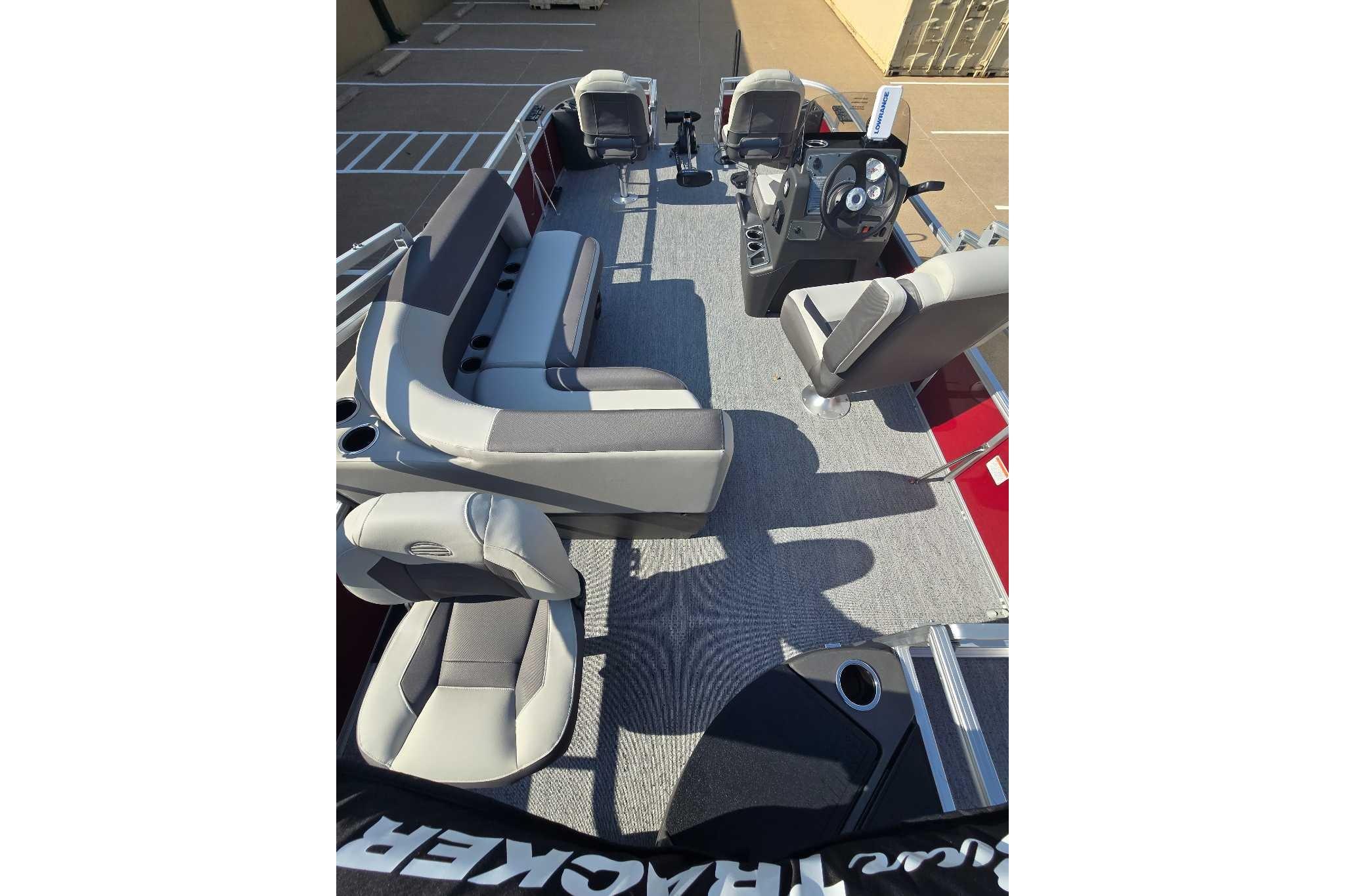 2026 Sun Tracker Bass Buggy 18 DLX pontoon boat interior with seating and steering console.