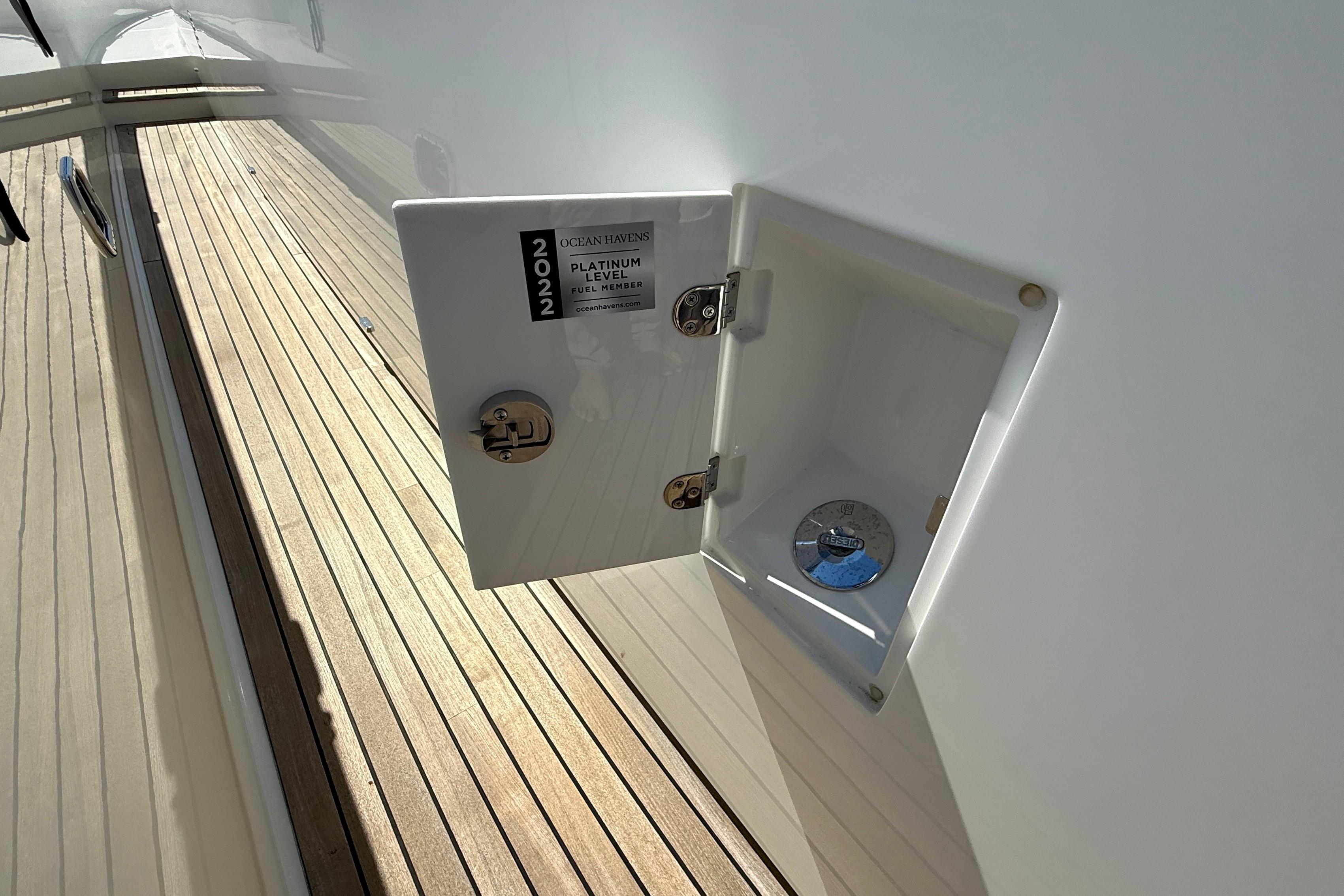 2022 Sirena 58 yacht deck with open fuel compartment, platinum level member badge.