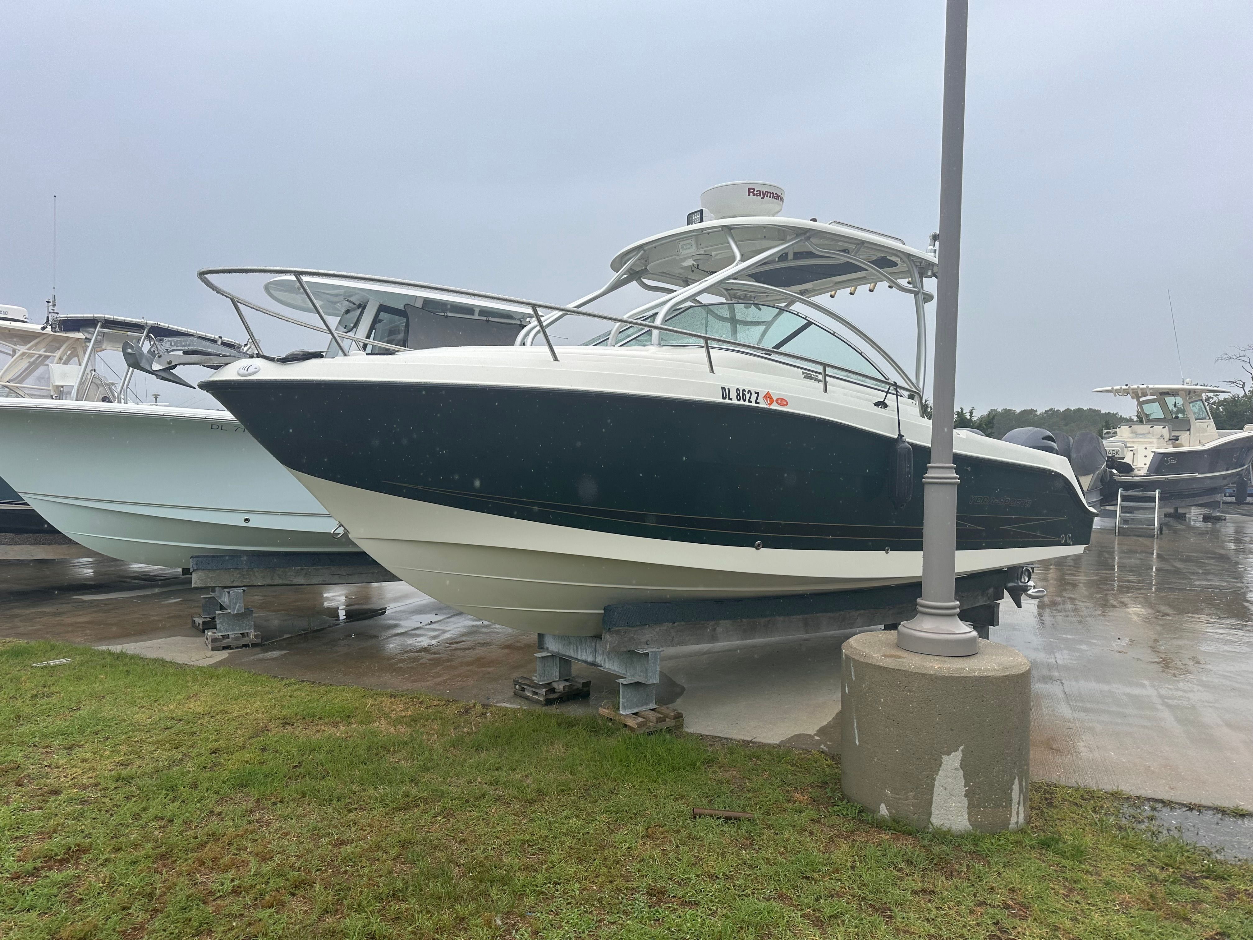A 2023 Hydra-Sports Vector-VX boat is on a dry dock. It features a sleek, modern design.
