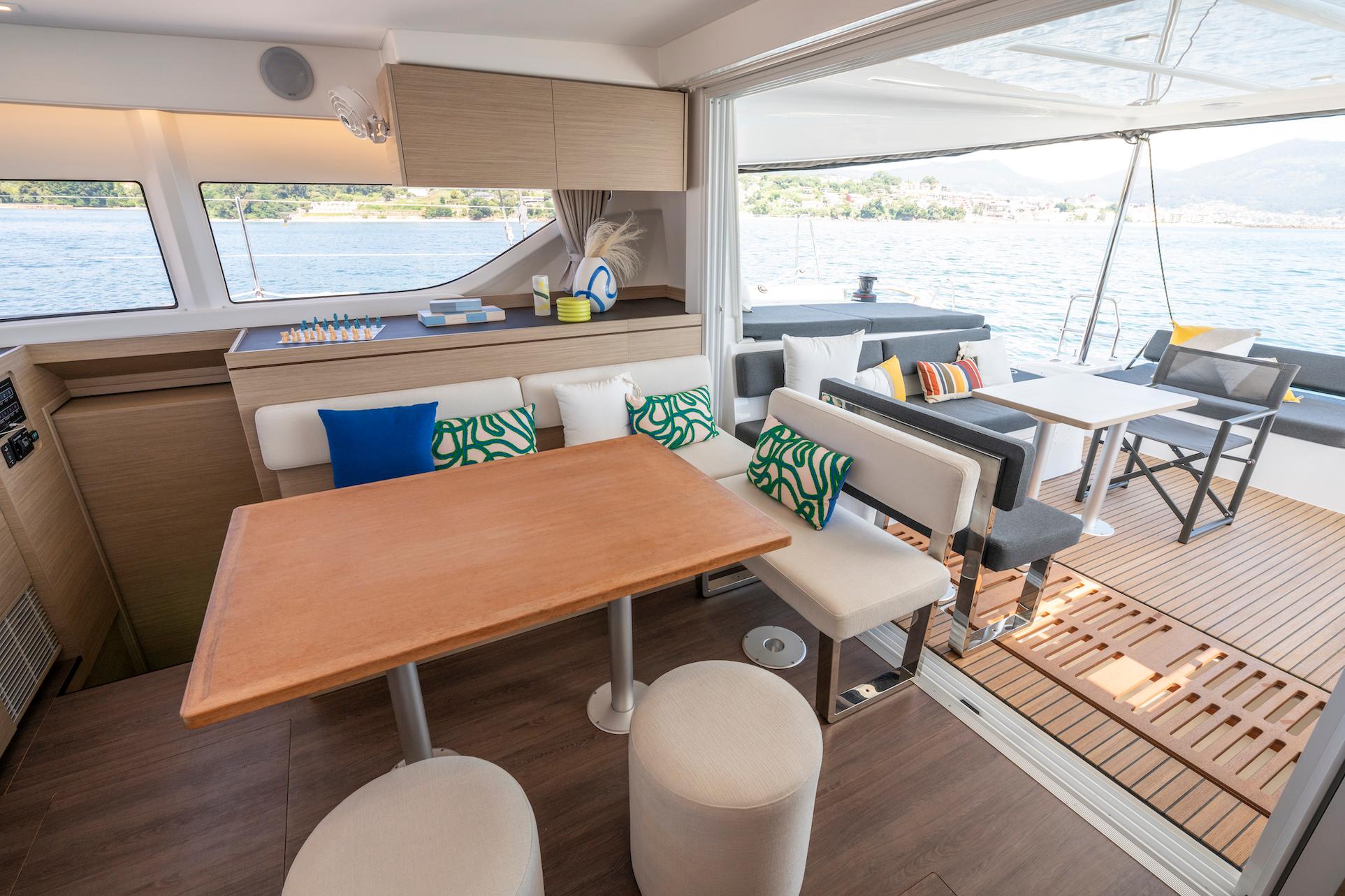 Interior of 2025 Lagoon 43 yacht with modern dining area and scenic ocean view.