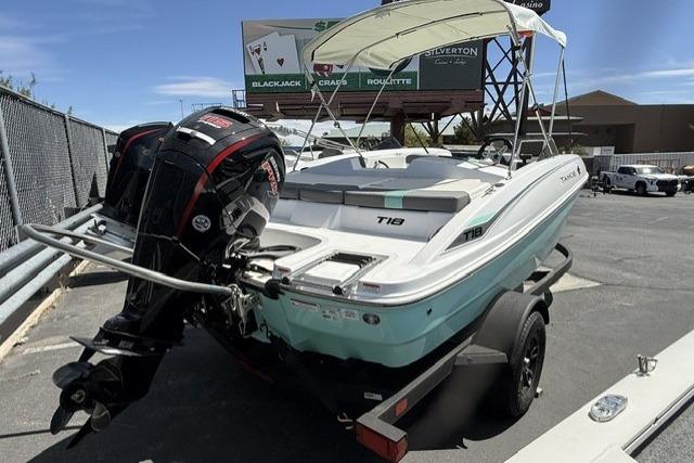 2026 Tahoe T18 boat with outboard motor on trailer, parked outdoors.