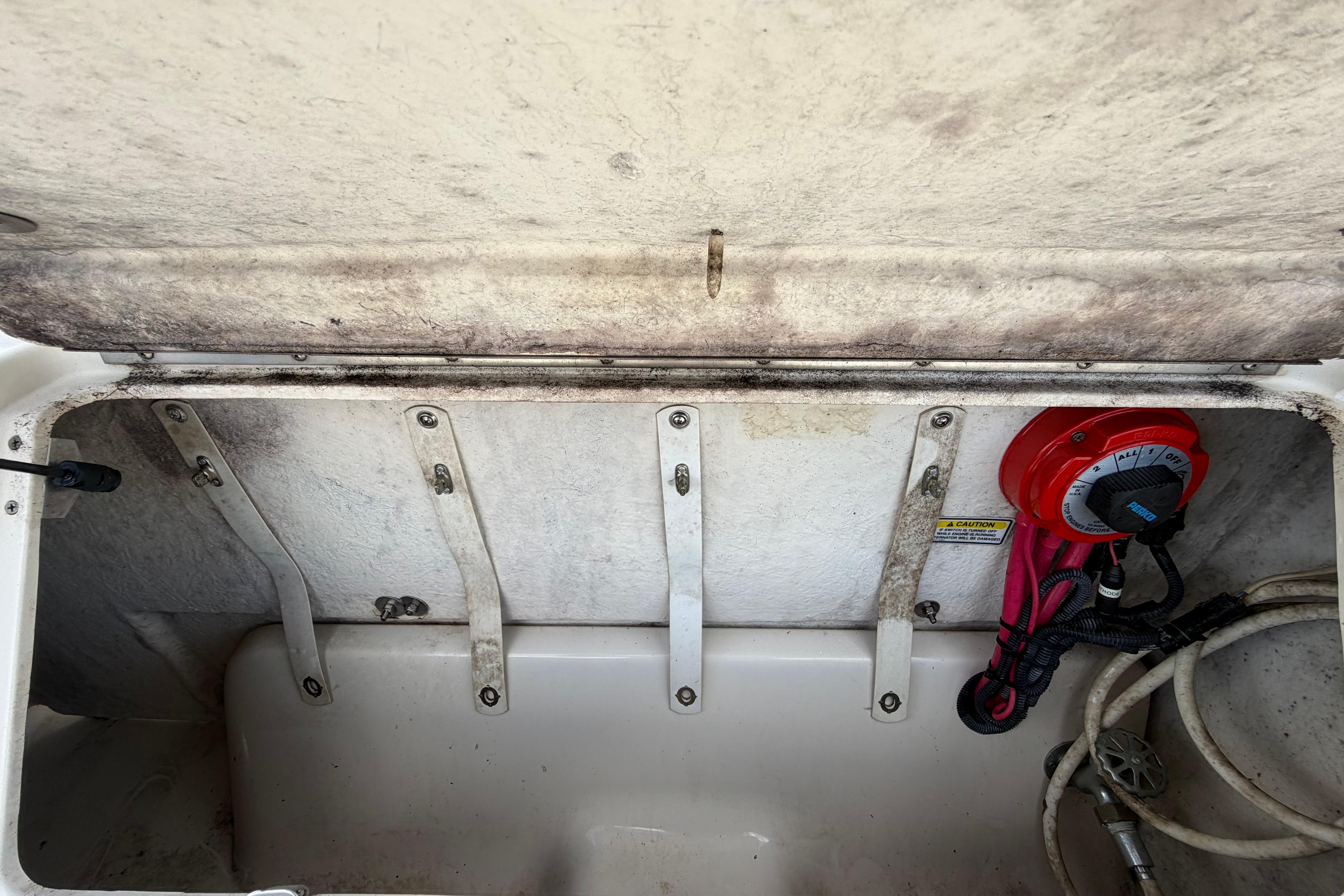 Open storage compartment of 2006 Sea Ray 250 Amberjack boat, showing interior details.