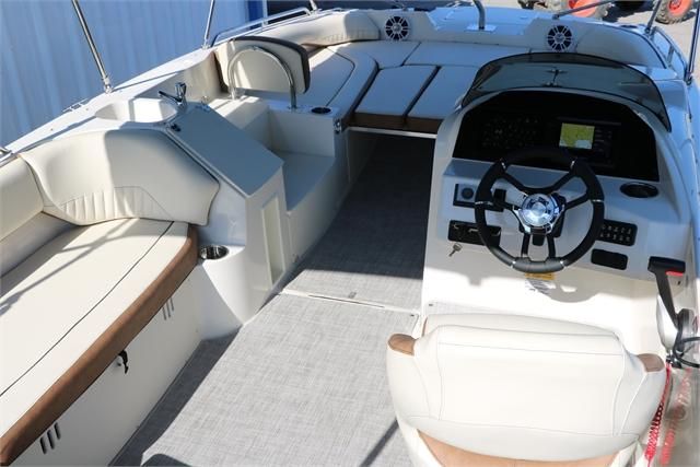 Interior view of a 2022 Stingray 212 SC boat with steering wheel and seating.
