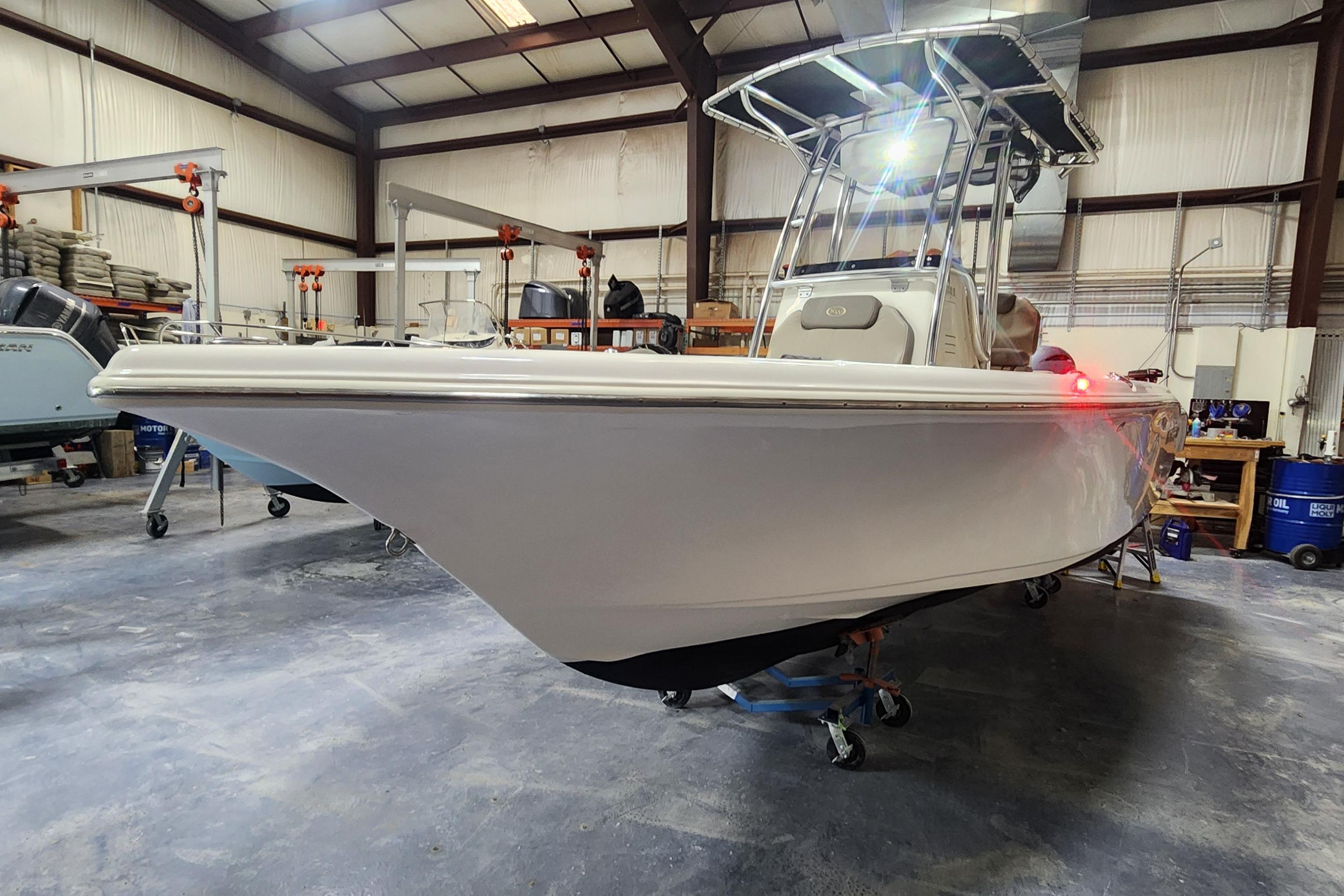 2023 Key West 219 FS boat in a warehouse, showcasing sleek design and modern features.