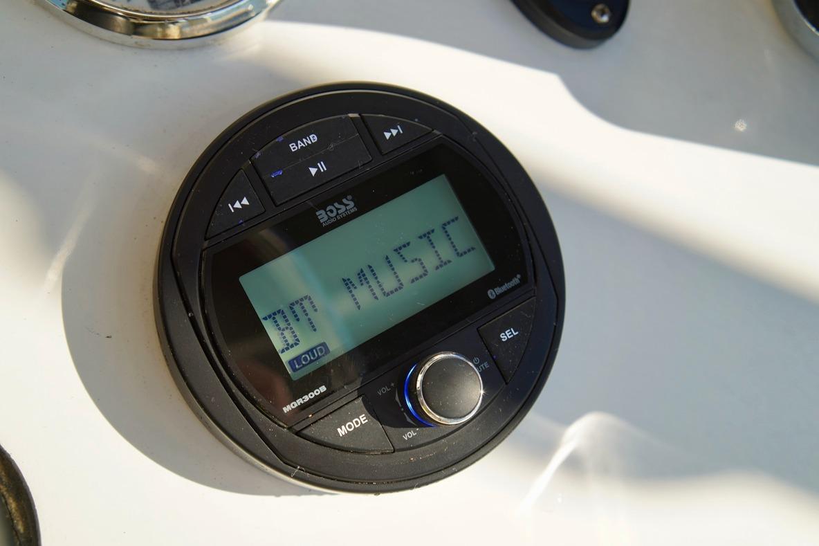 Audio system on 1970 Aquasport 222 Flatback boat displaying "BT MUSIC".