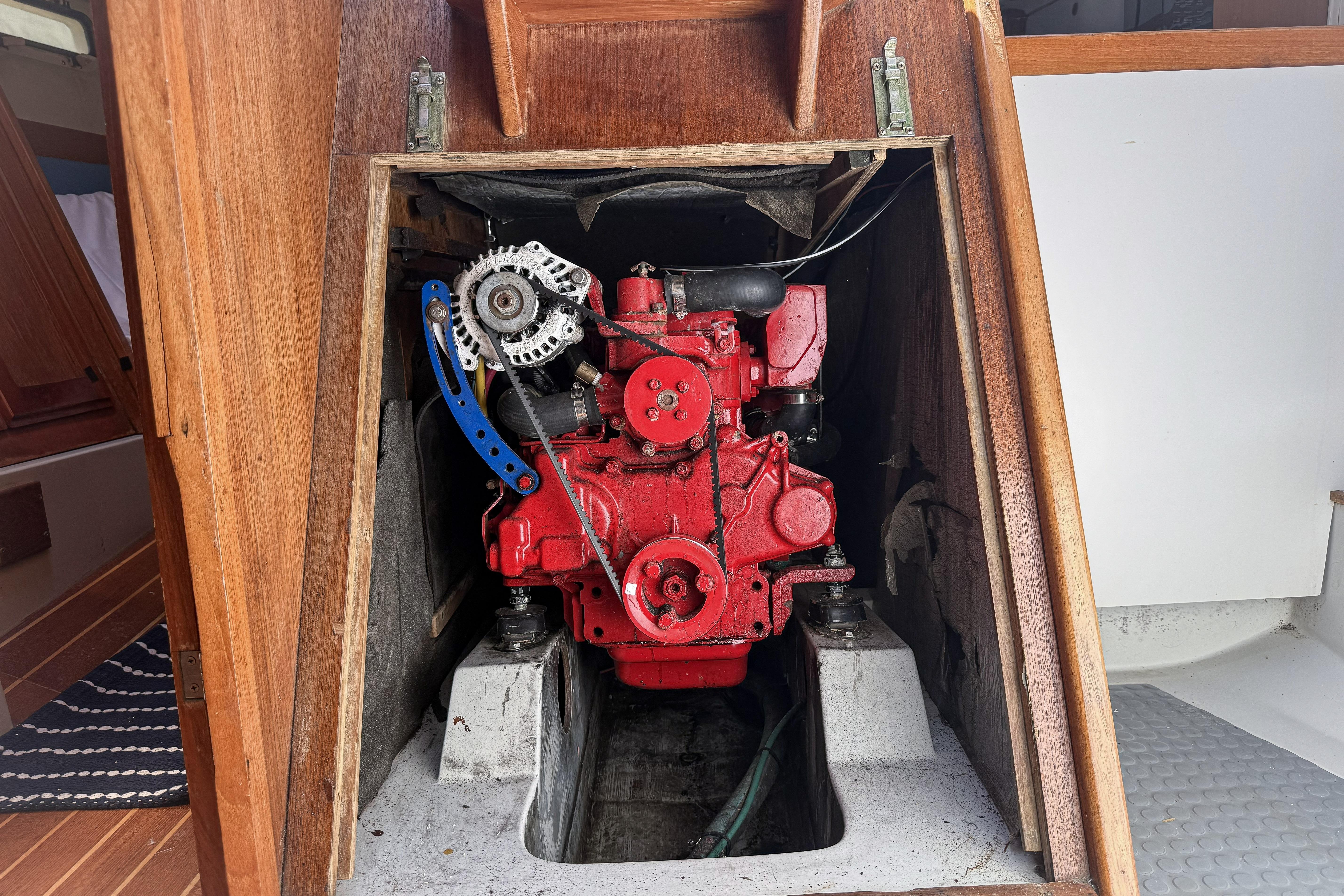 Engine compartment of a 1988 Oday 40 sailboat, featuring a red engine.