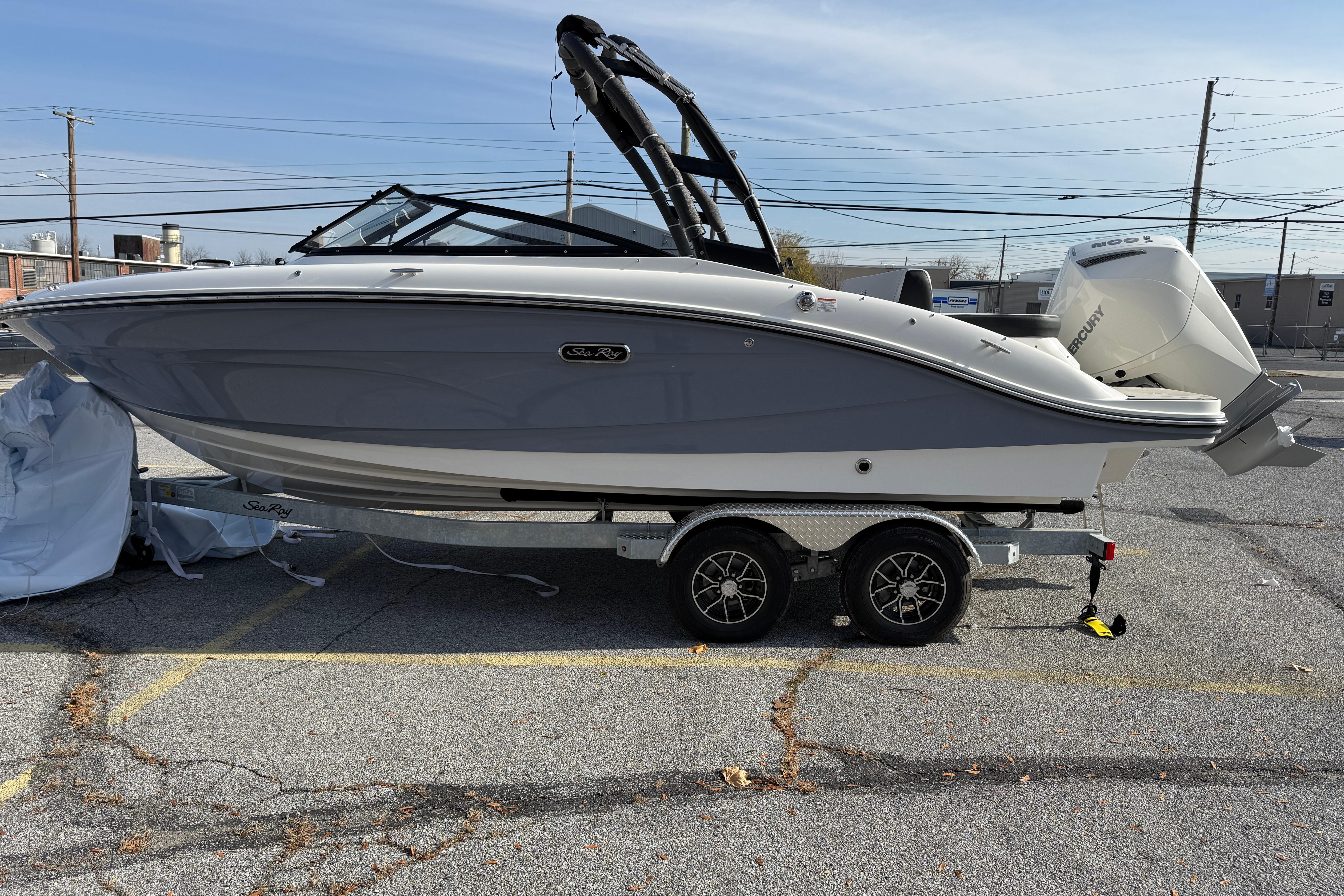 2026 Sea Ray SPX 210 Outboard boat on trailer in parking lot.