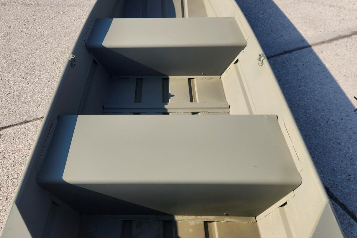 2026 Tracker Grizzly 12 Jon boat interior with bench seats, shown on pavement.
