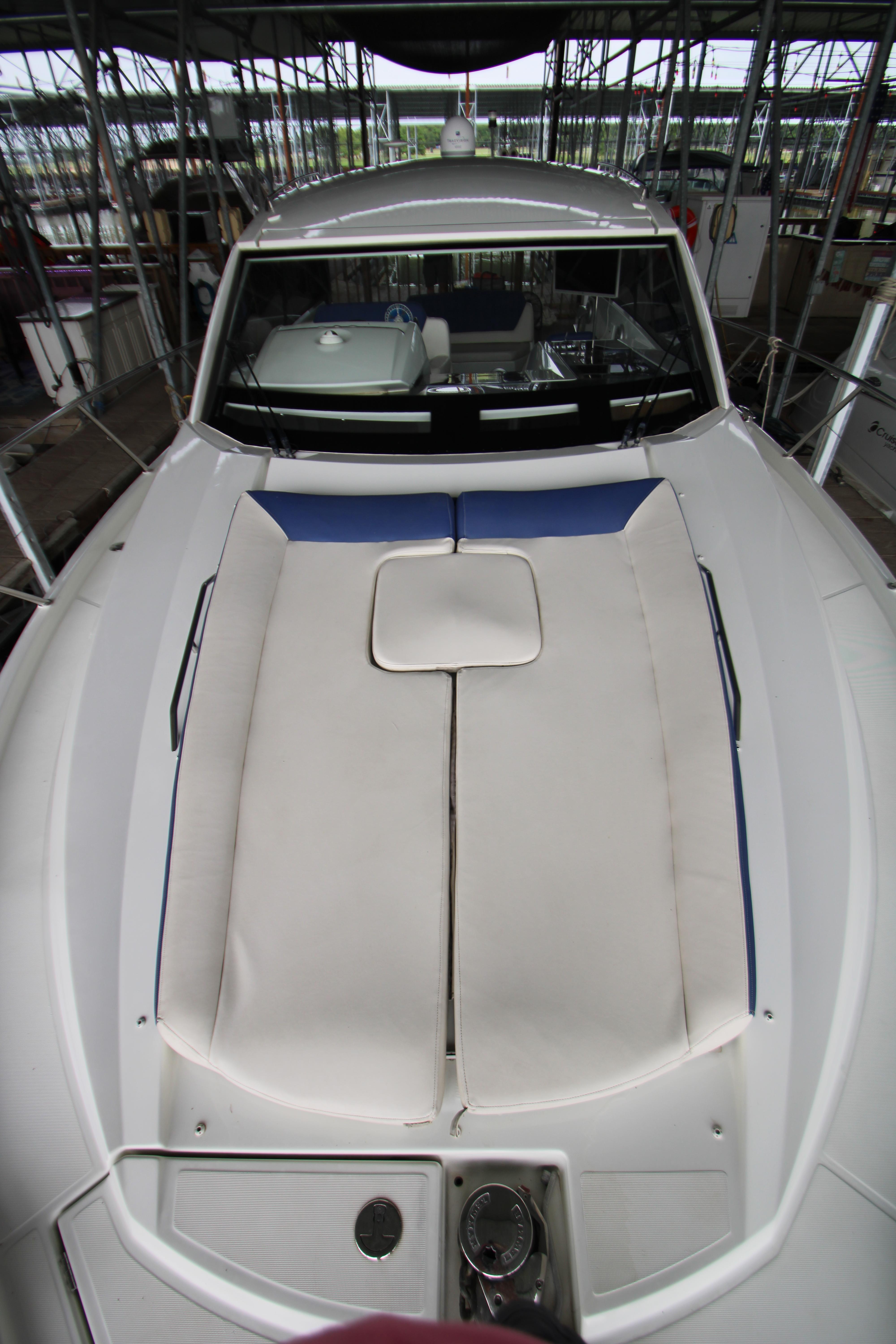2012 Jeanneau Leader 10 boat with cushioned deck, docked in a marina.