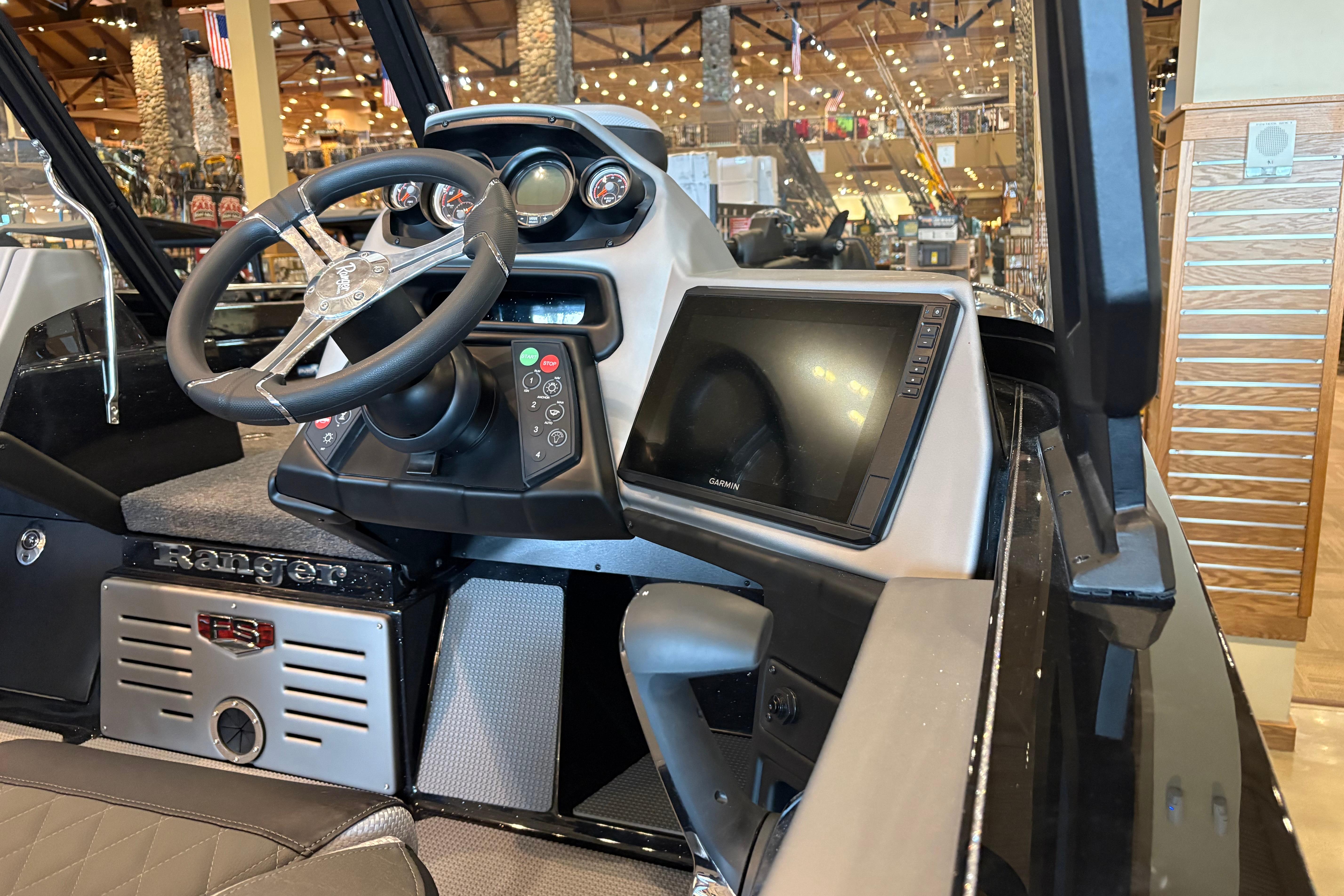 2026 Ranger 621FS Cup-Equipped boat dashboard with steering wheel and Garmin display.