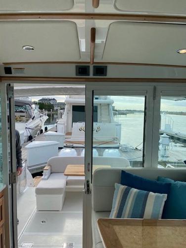 Interior view of 2025 Back Cove 39O yacht with docked boats in background.