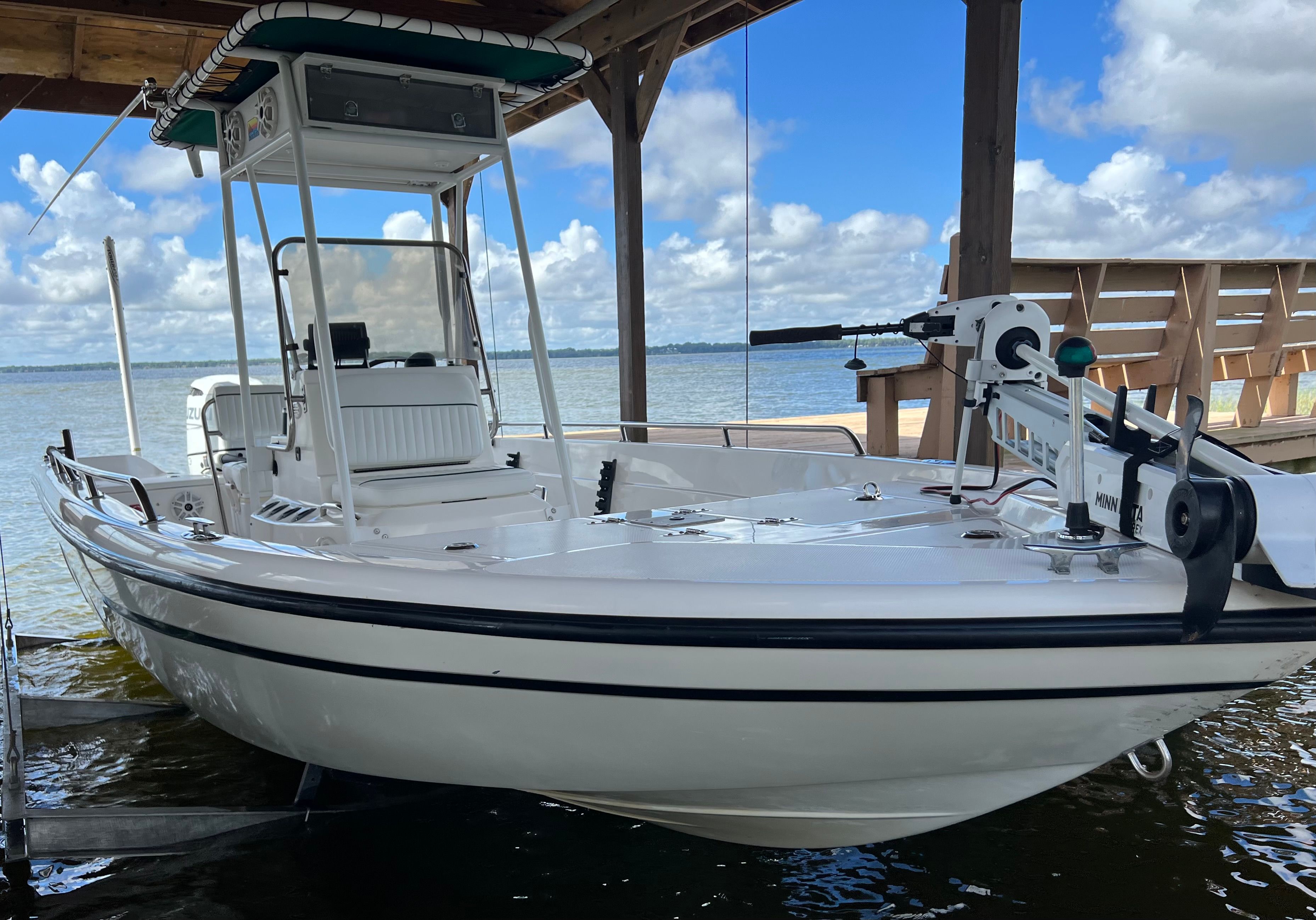 1999 Skeeter ZX2200 boat under dock roof by the lake.