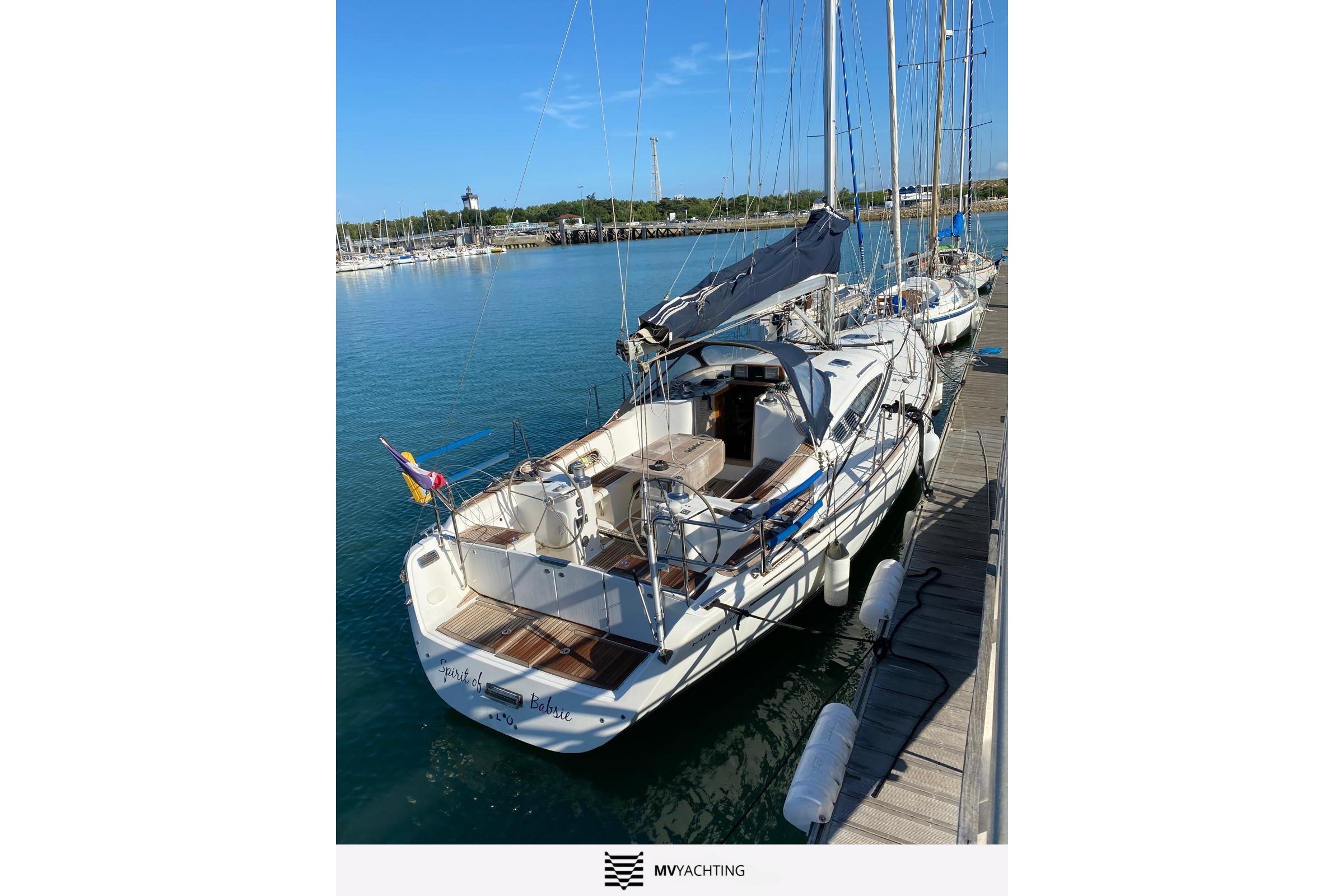 Sailboat Maxi 1300, 2010 model, docked at marina with clear blue water.