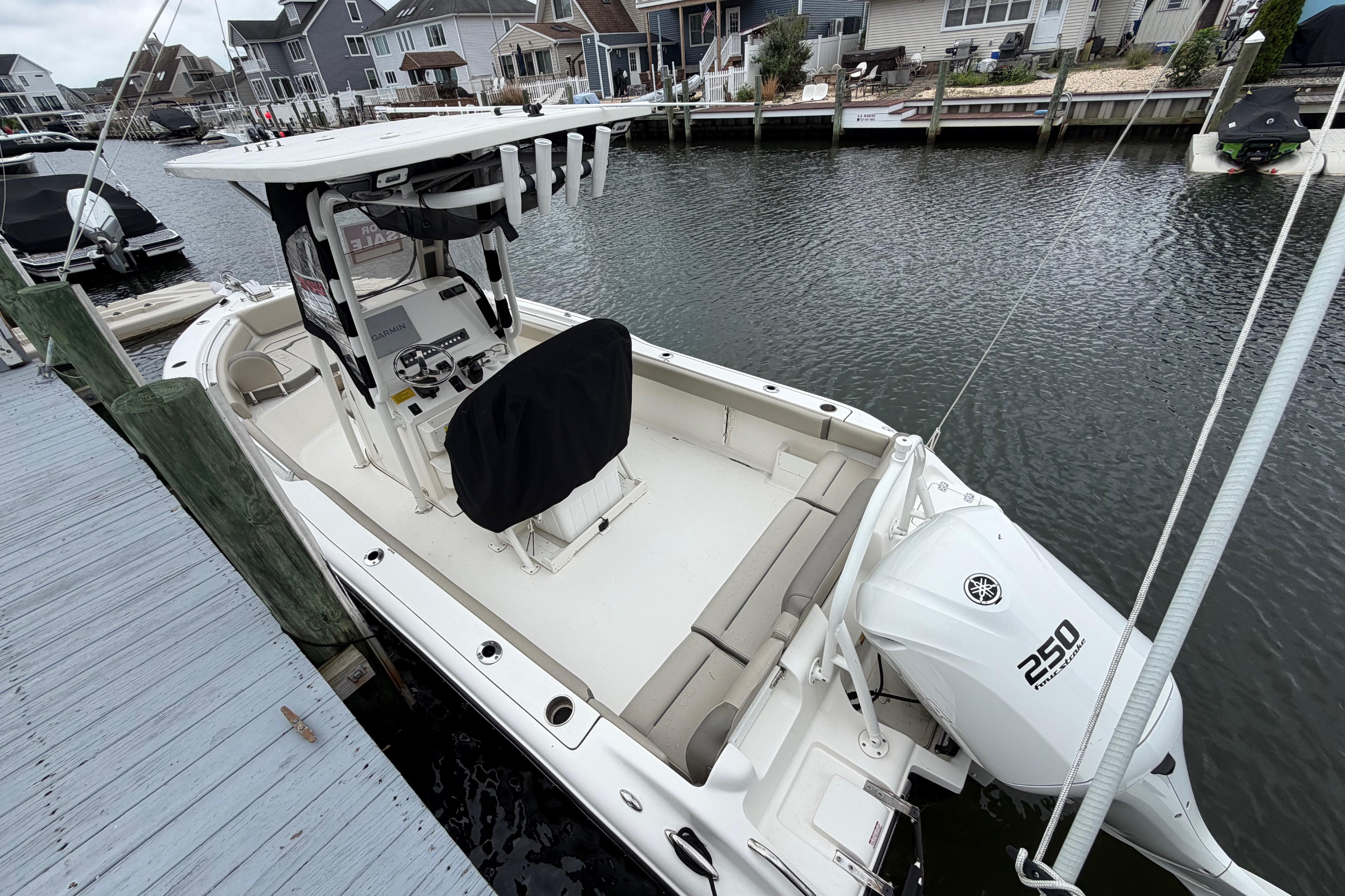 2022 Key West 239 FS boat docked, featuring Yamaha 250 engine, in a residential marina.