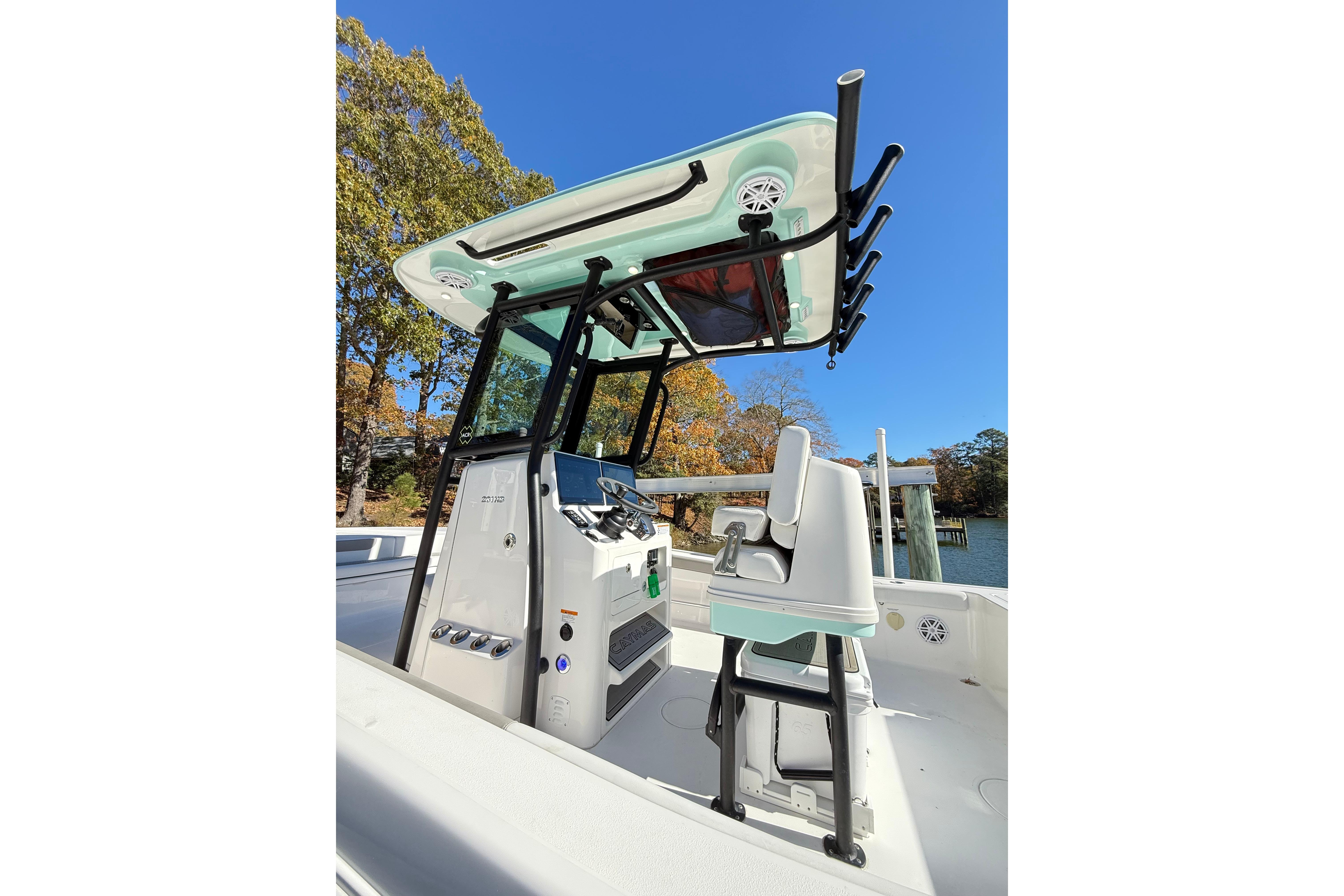 2023 Caymas 281 HB boat interior with helm station and seating, under clear blue sky.