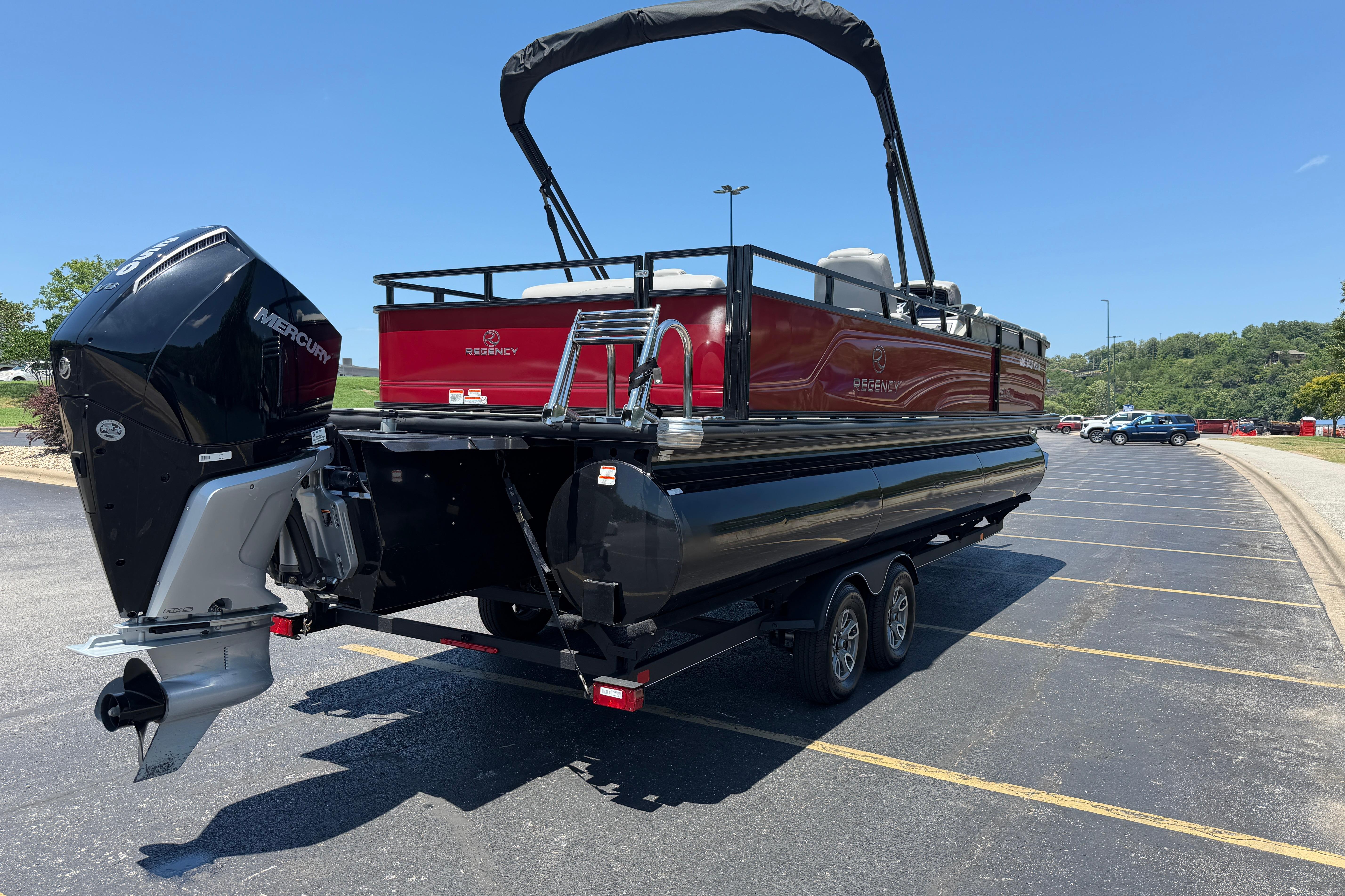 2024 Regency R250DL3 pontoon boat with Mercury outboard engine on a trailer.