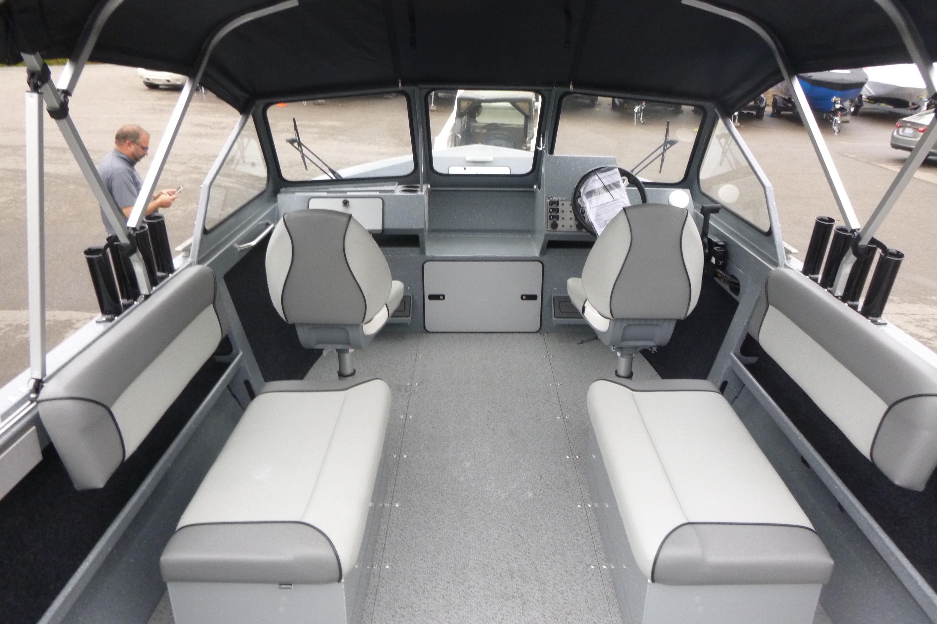 Interior of 2026 KingFisher 2025 Escape boat, featuring seating and control panel.