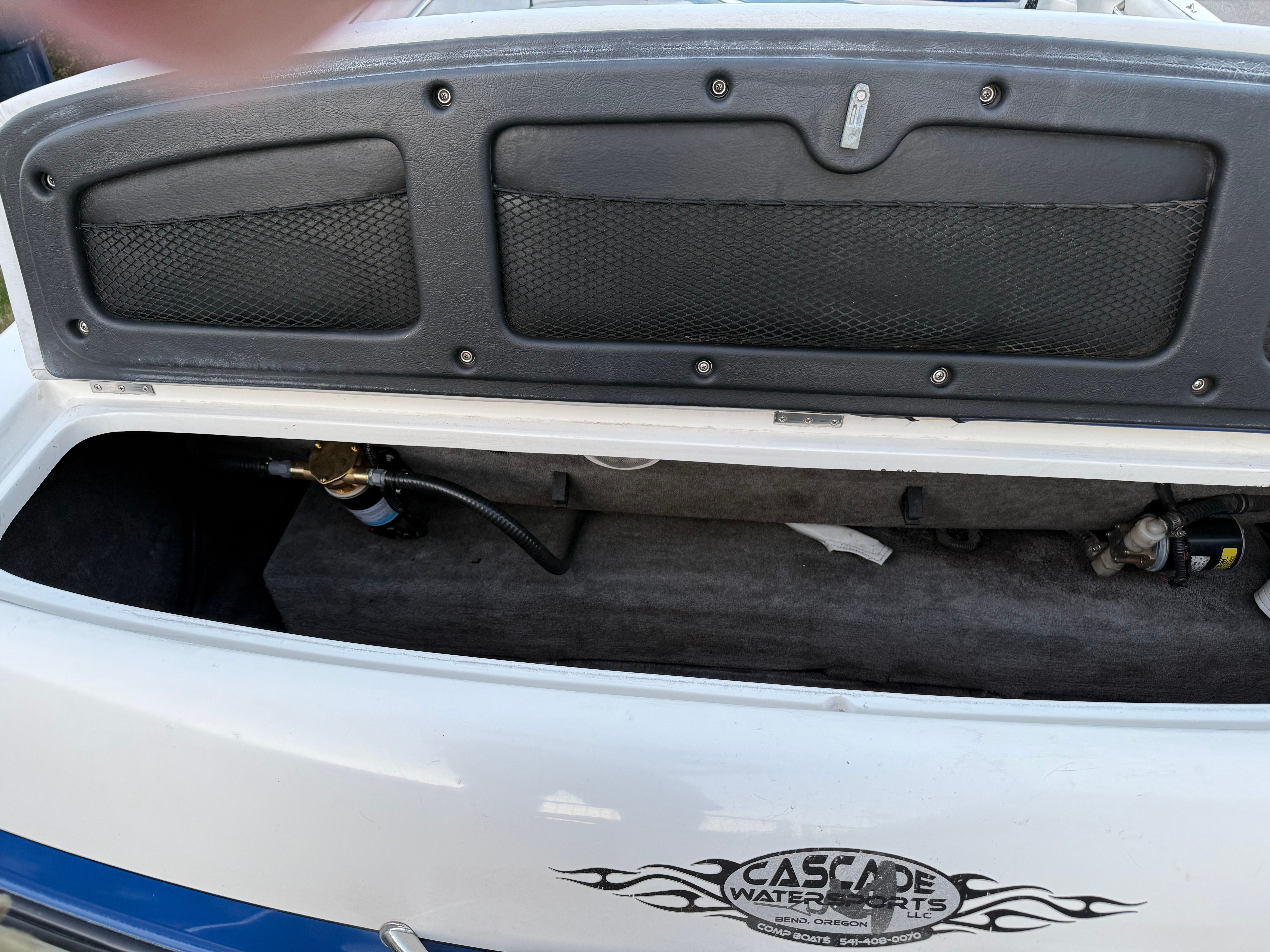 MB Sports 220 boat, open storage compartment, Cascade Water Sports logo.