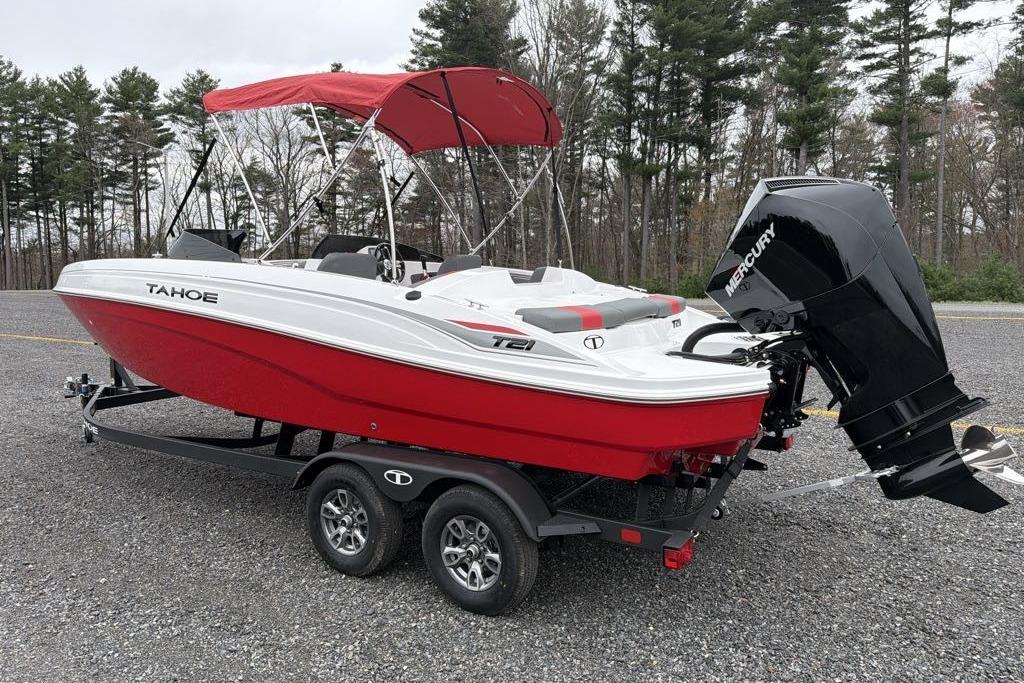 2026 Tahoe T21 boat with red hull, Mercury engine, and canopy on a trailer.