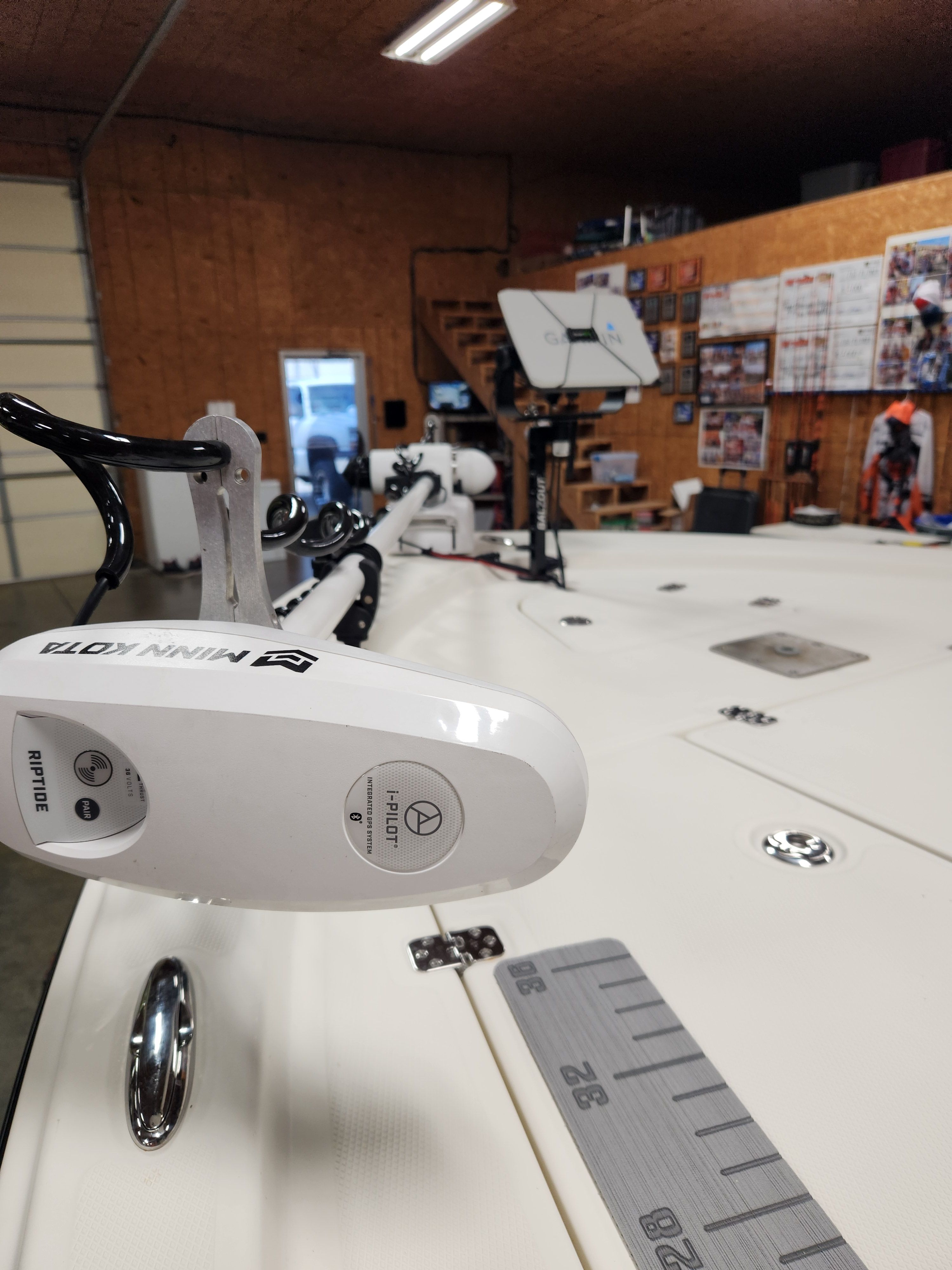 Interior view of a 2014 Mako 21 LTS boat with fishing gear and measuring scale.