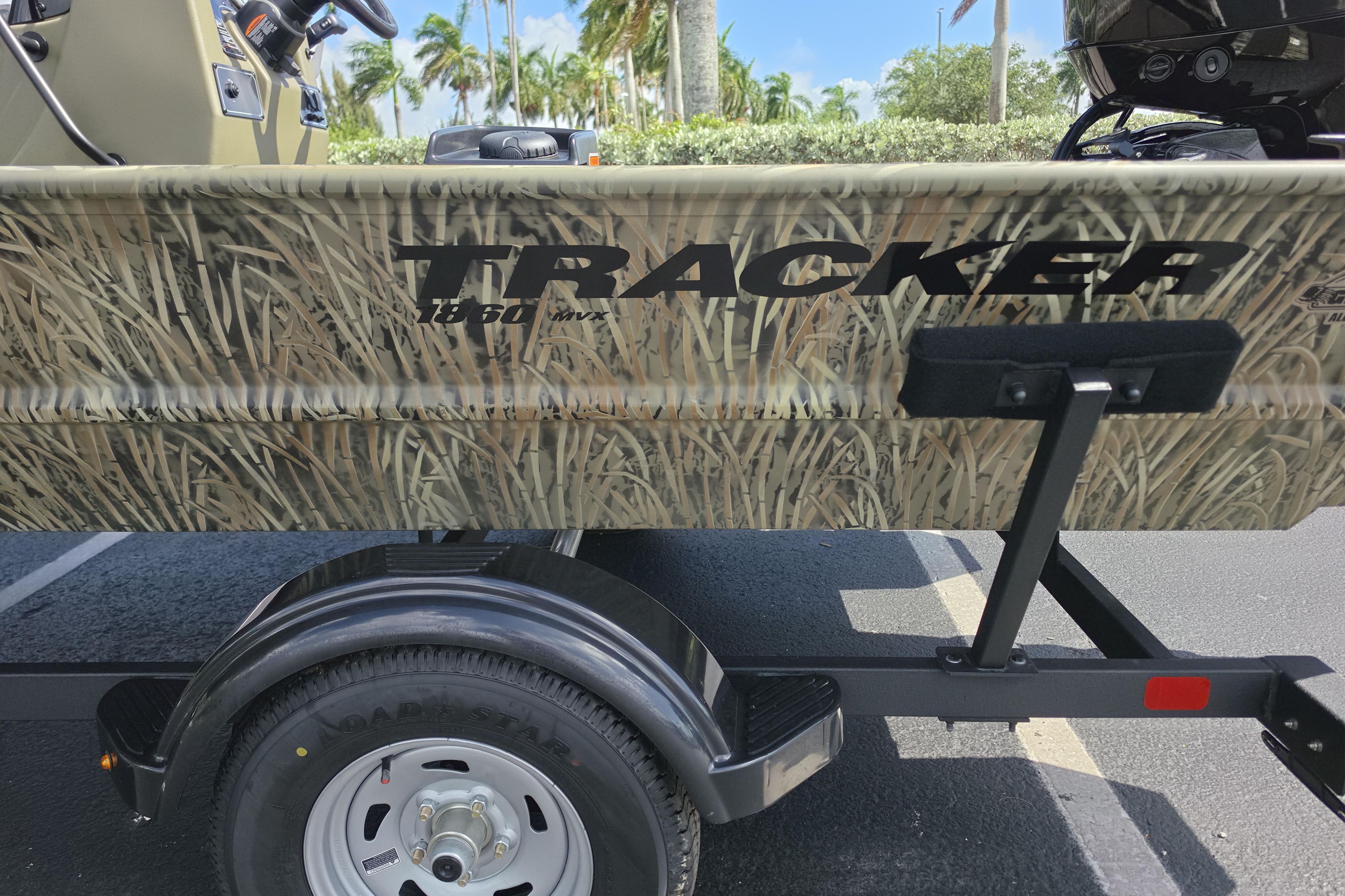 2026 Tracker Grizzly 1860 CC boat with camouflage design on a trailer.