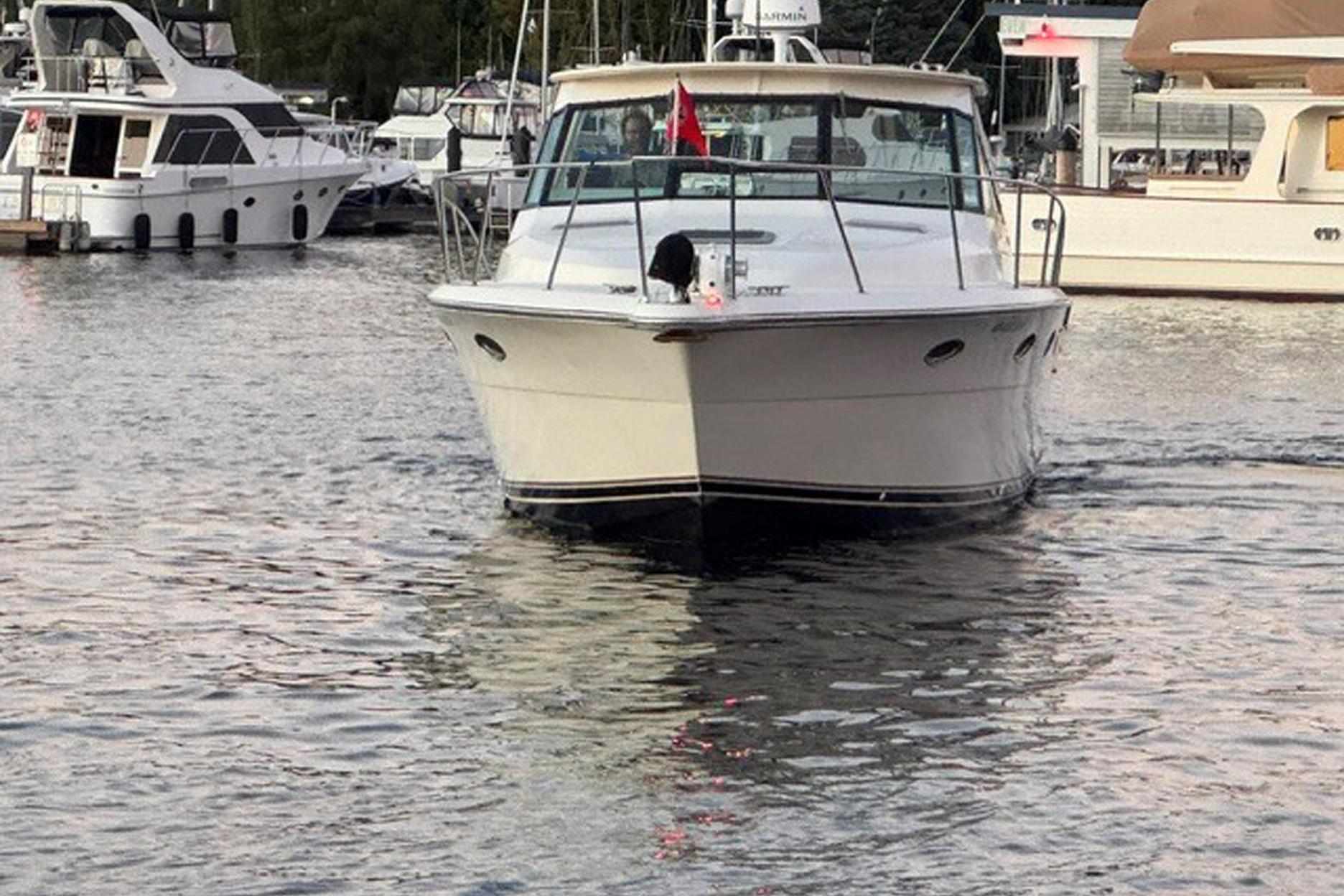 1988 Tiara Yachts 3300 Open cruising in a marina, surrounded by other boats.