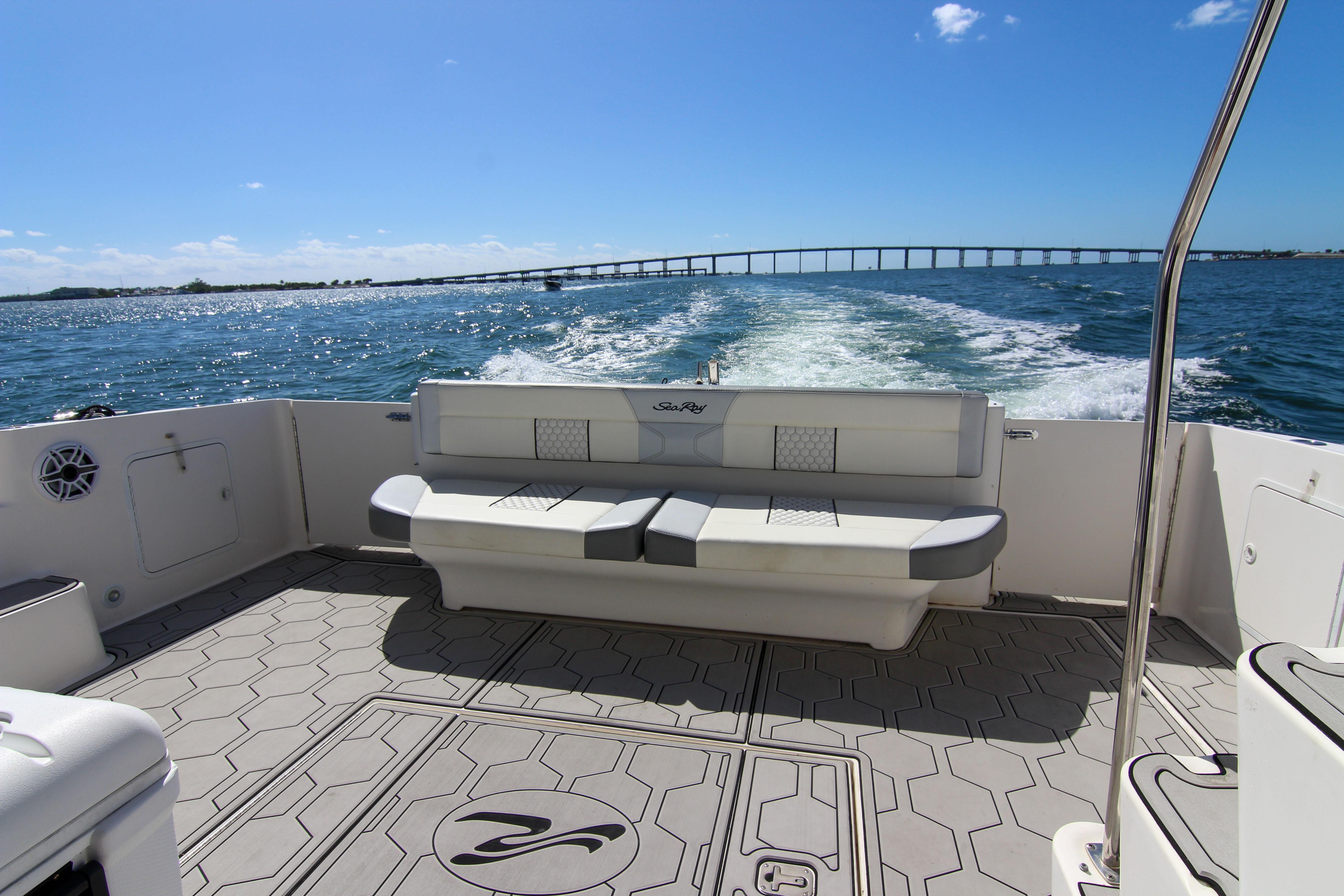 2000 Sea Ray 450 Express Bridge cruising on open water, featuring spacious deck seating.