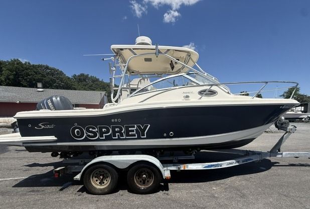 A 2004 Scout 242 Abaco boat on a trailer, featuring a blue hull and a hardtop.