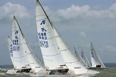Sailboats racing on the water, Ontario Etchells 1982 model, with GBR sail numbers.