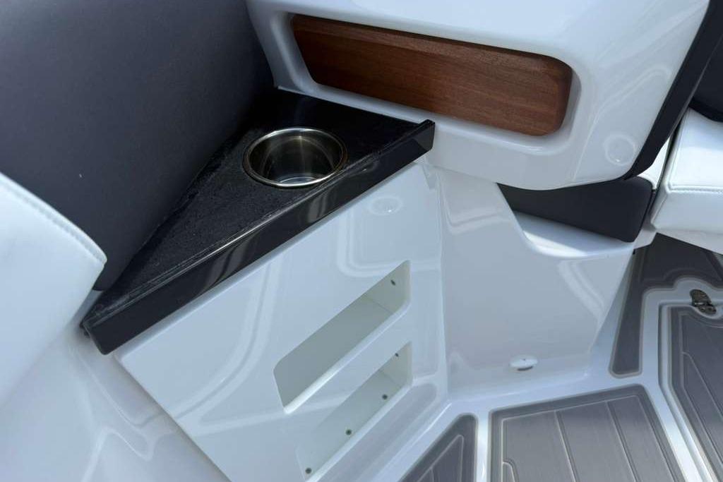 Interior detail of 2026 Monterey Elite 30 OB boat with cup holder and storage.