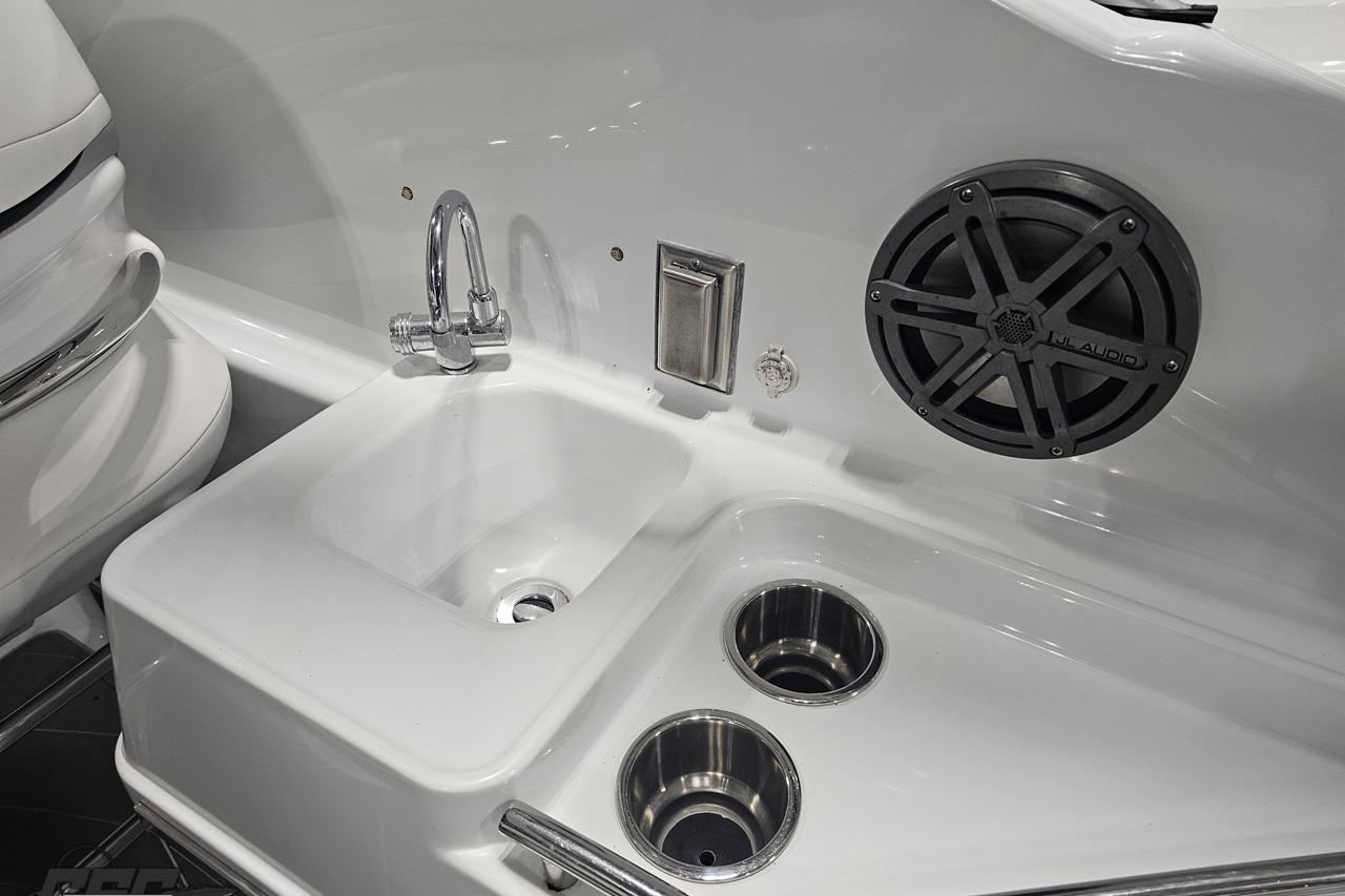 2008 Baja 335 Performance boat interior with sink, faucet, and JL Audio speaker.
