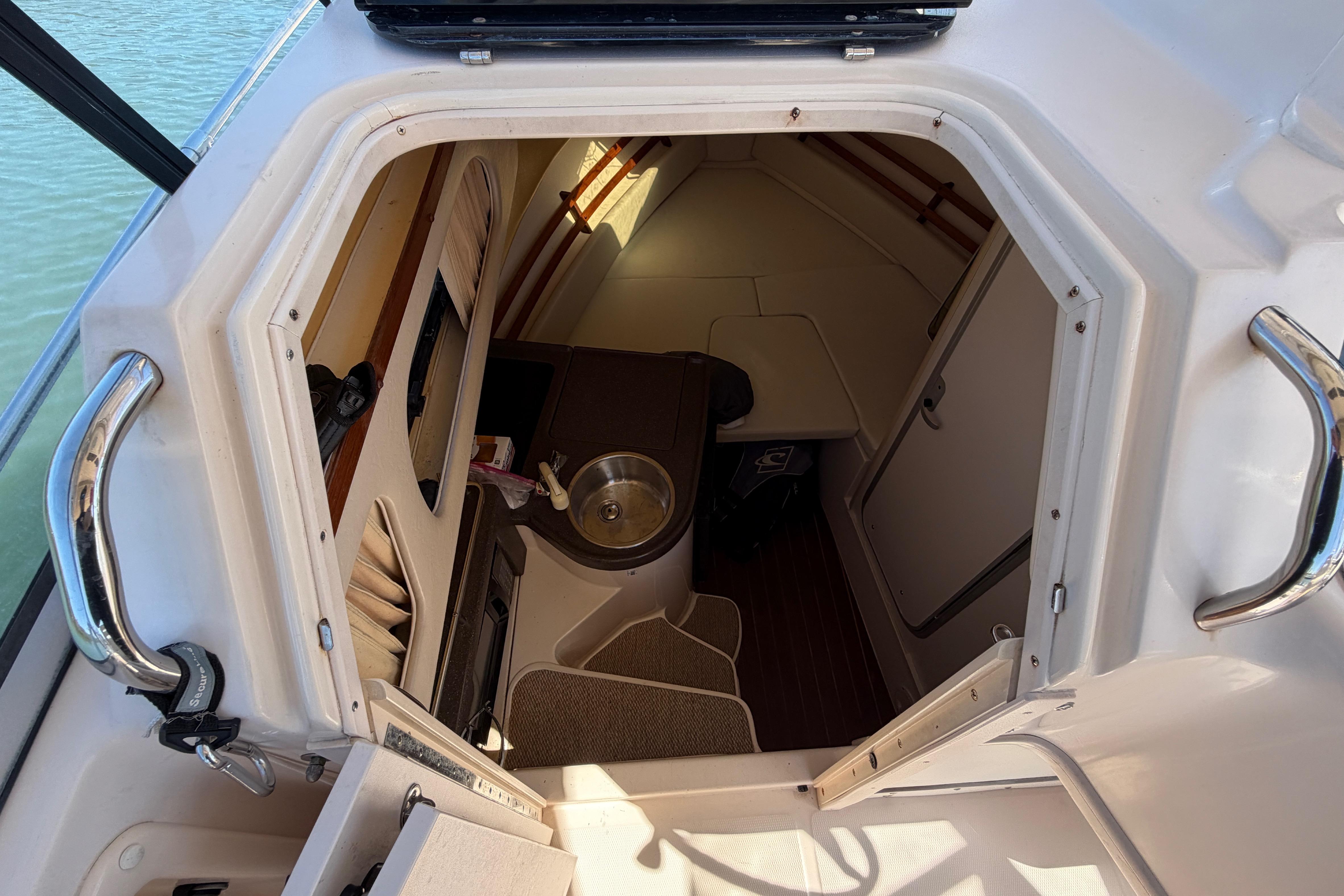 2006 Grady-White Sailfish 282 cabin interior with sink and seating area.