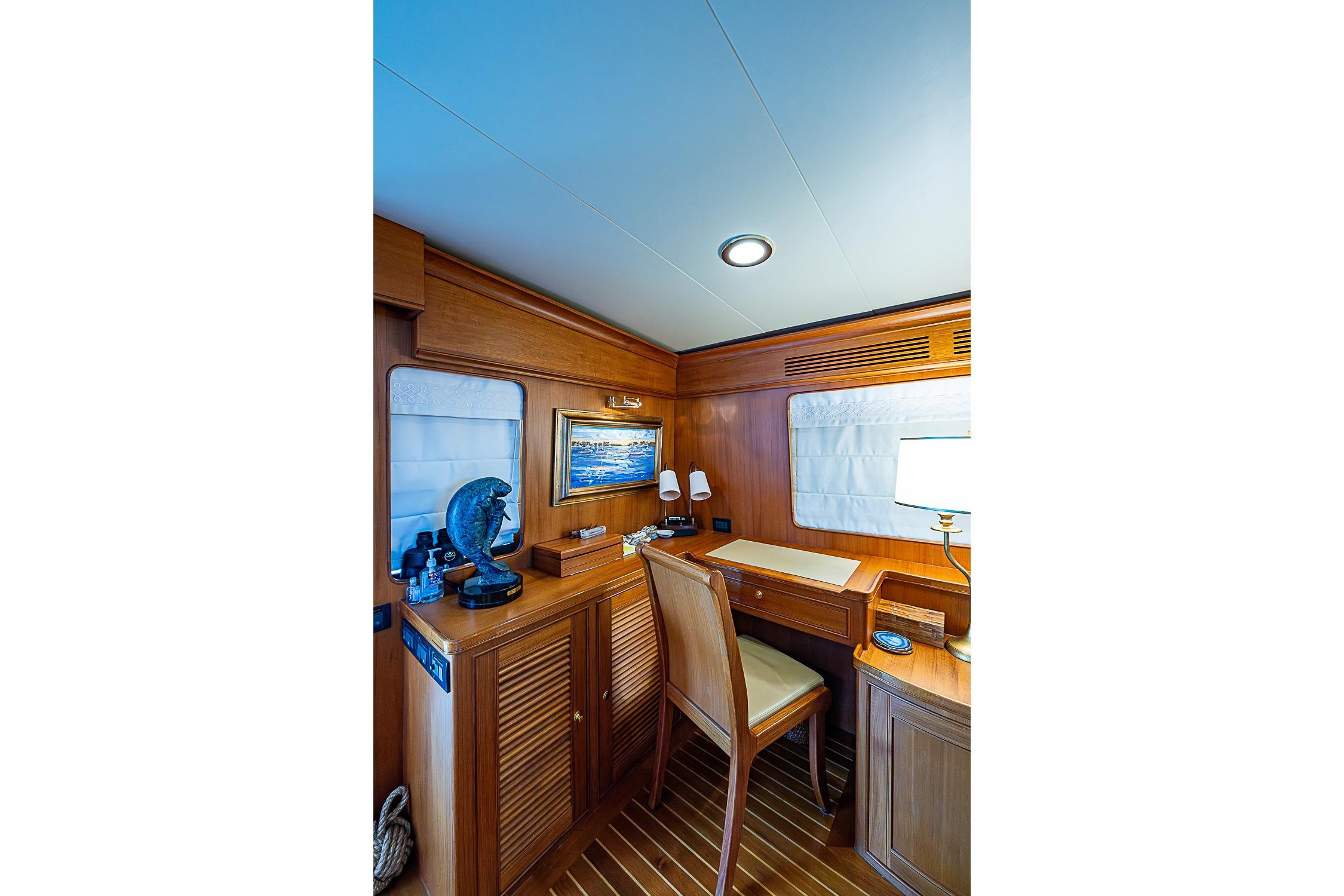 Luxurious wooden interior of 2014 Marlow 80 Explorer yacht with desk and decor.