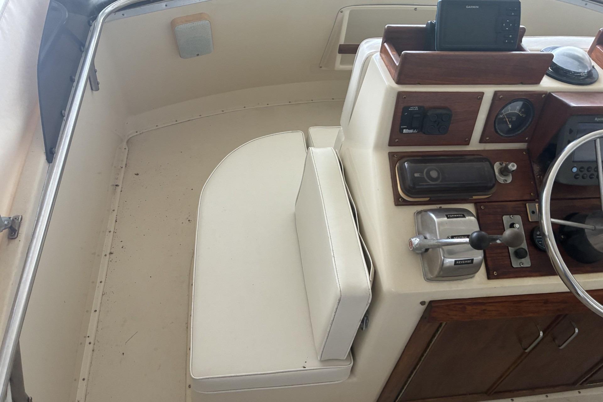 1980 Chris-Craft 360 Commander helm with steering wheel and navigation equipment.