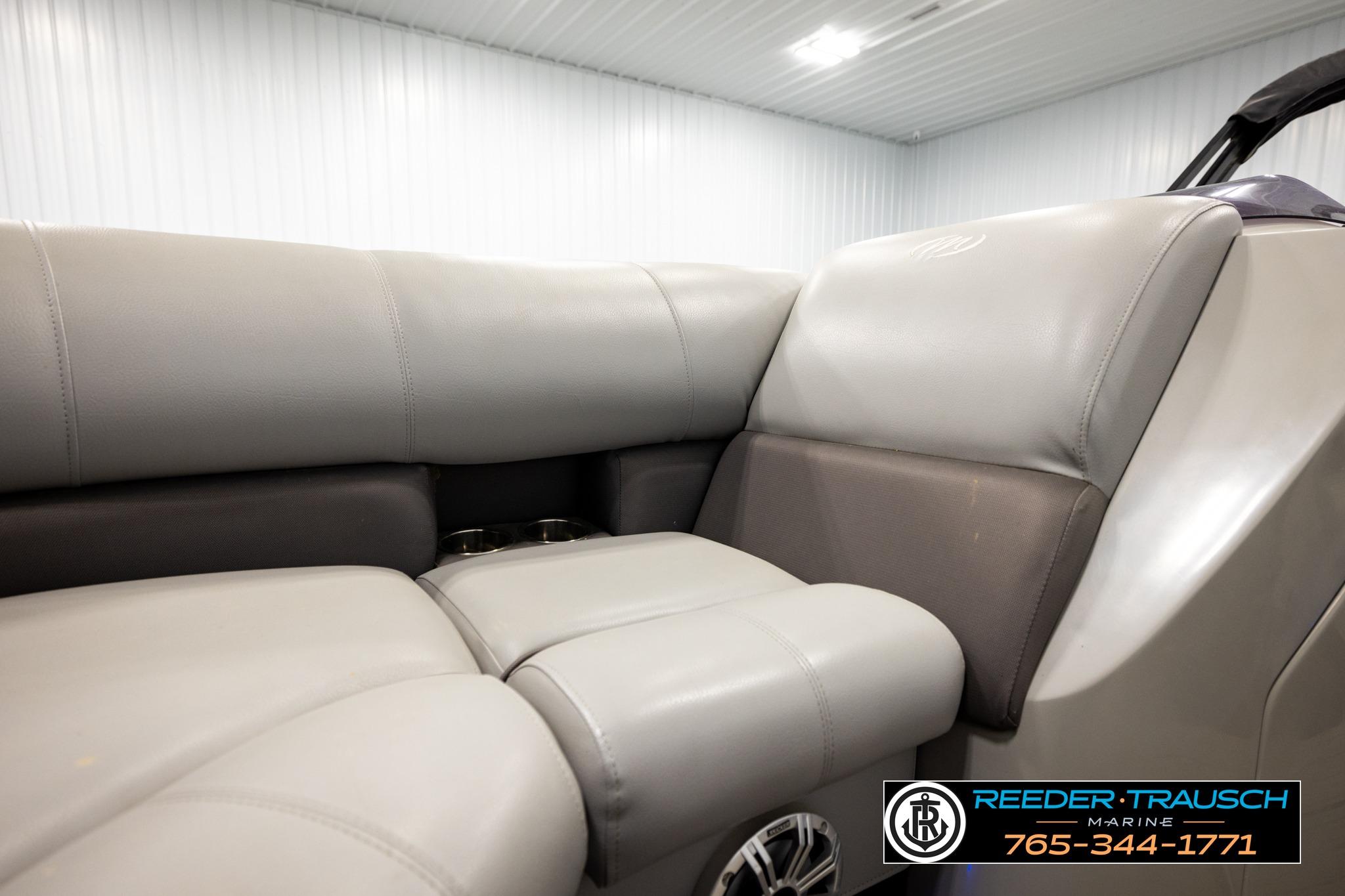 2019 Manitou Oasis SR VP boat interior with gray leather seating in showroom.