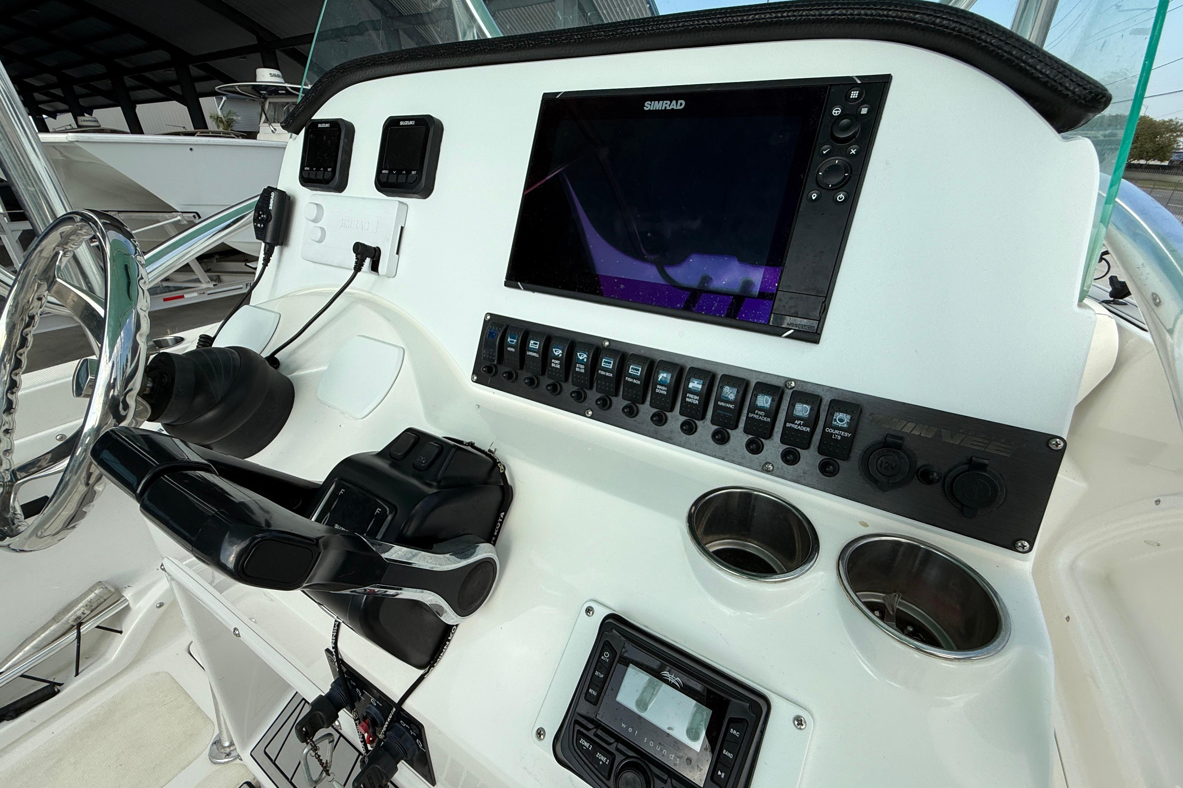 2020 Twin Vee 240 GFX CC boat dashboard with Simrad display and control panel.