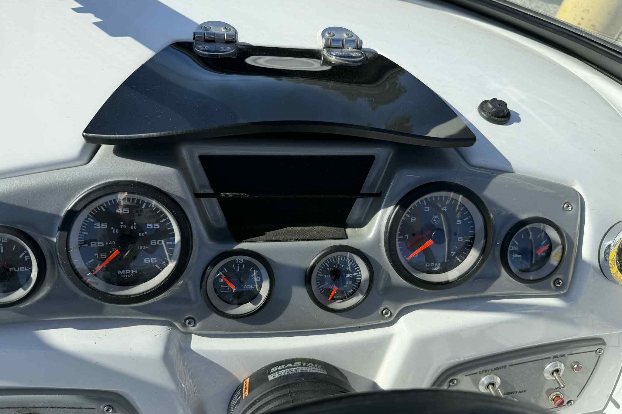 Dashboard of a 2021 Tahoe 550 TS boat with gauges and controls.