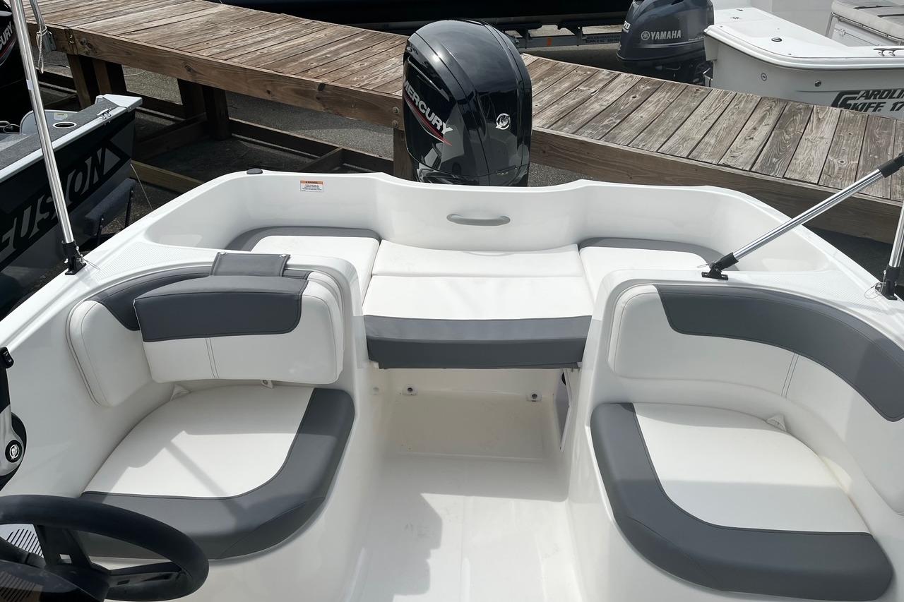 2026 Bayliner Element E16 boat interior with seating and Mercury outboard motor.