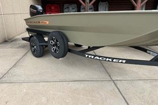 2026 Tracker Grizzly 1756 T Marsh boat on trailer, parked on concrete surface.