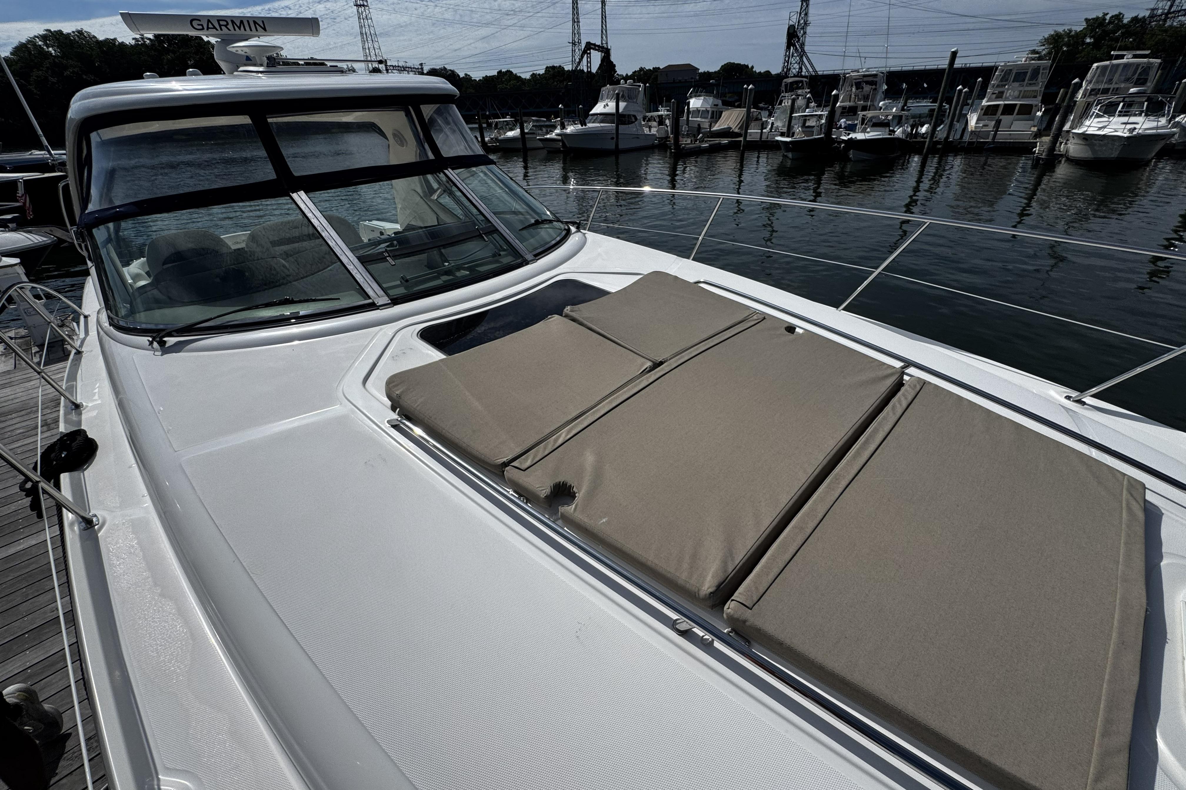 2006 Sea Ray 40 Sundancer yacht with sunpads, docked at marina.